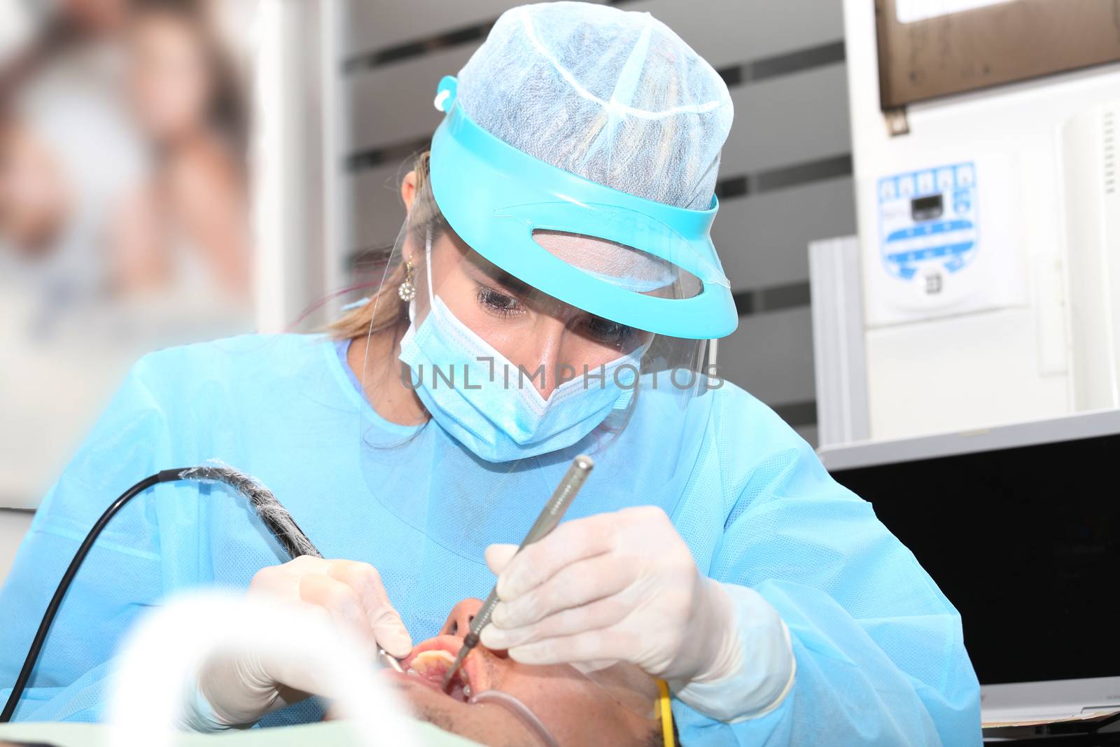 close up of a dentist cleaning and polishing the teeth of a patient.