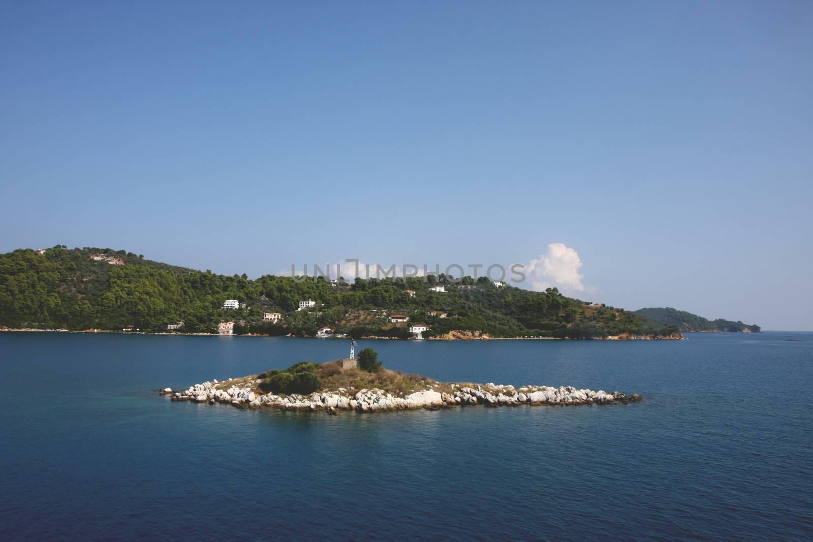 Small island close to Greek island Skiathos at Mediterranean sea