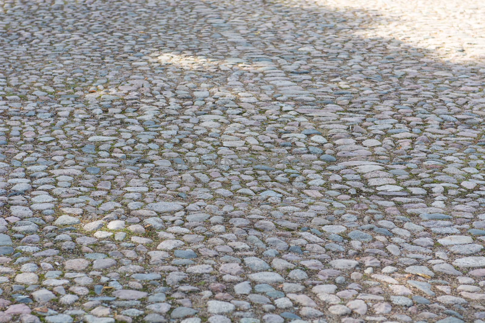 Background of an old cobble stone pavement with line pattern