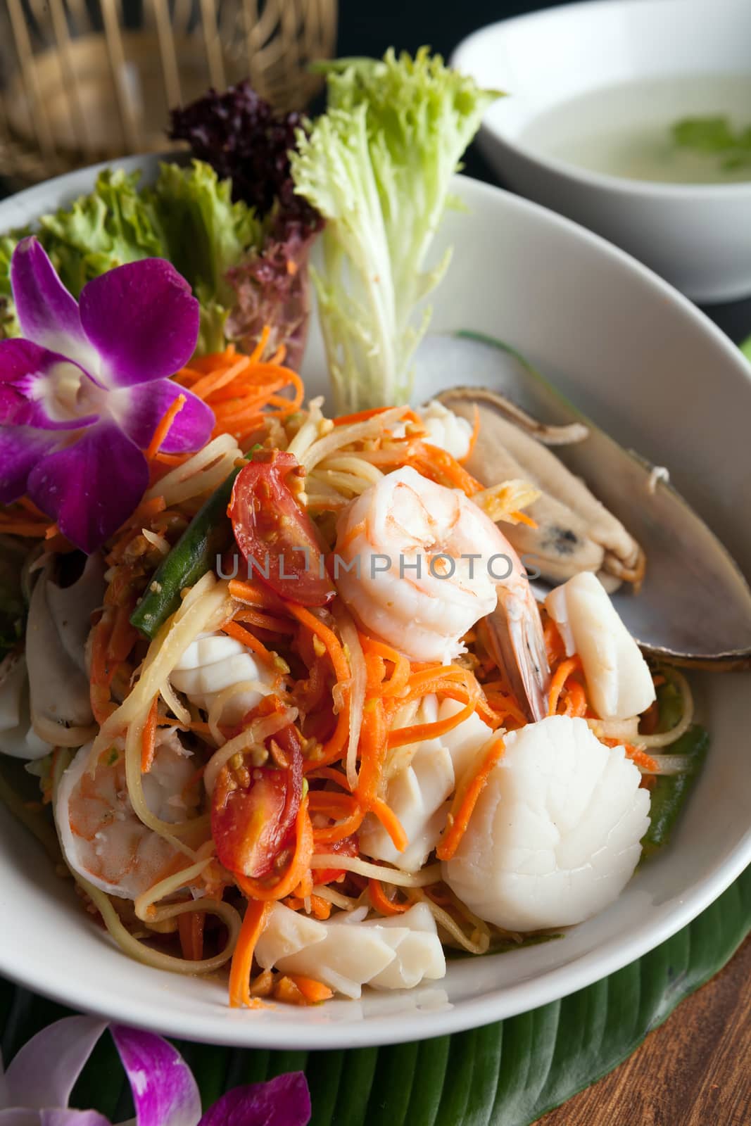 Traditional dish of freshly prepared Thai food.  Thai seafood and som tum green papaya salad.