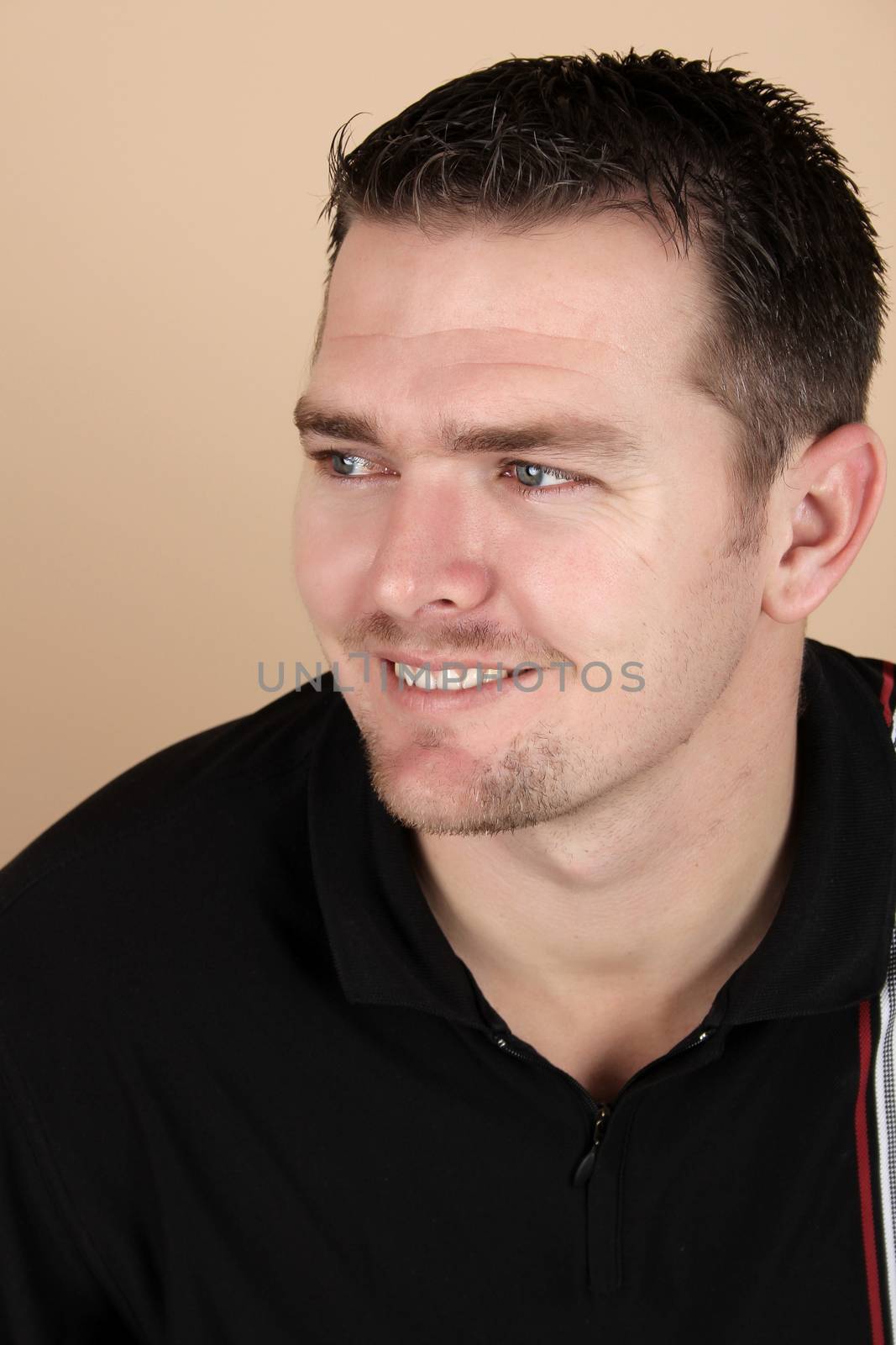 Attractive brunette male against a light background
