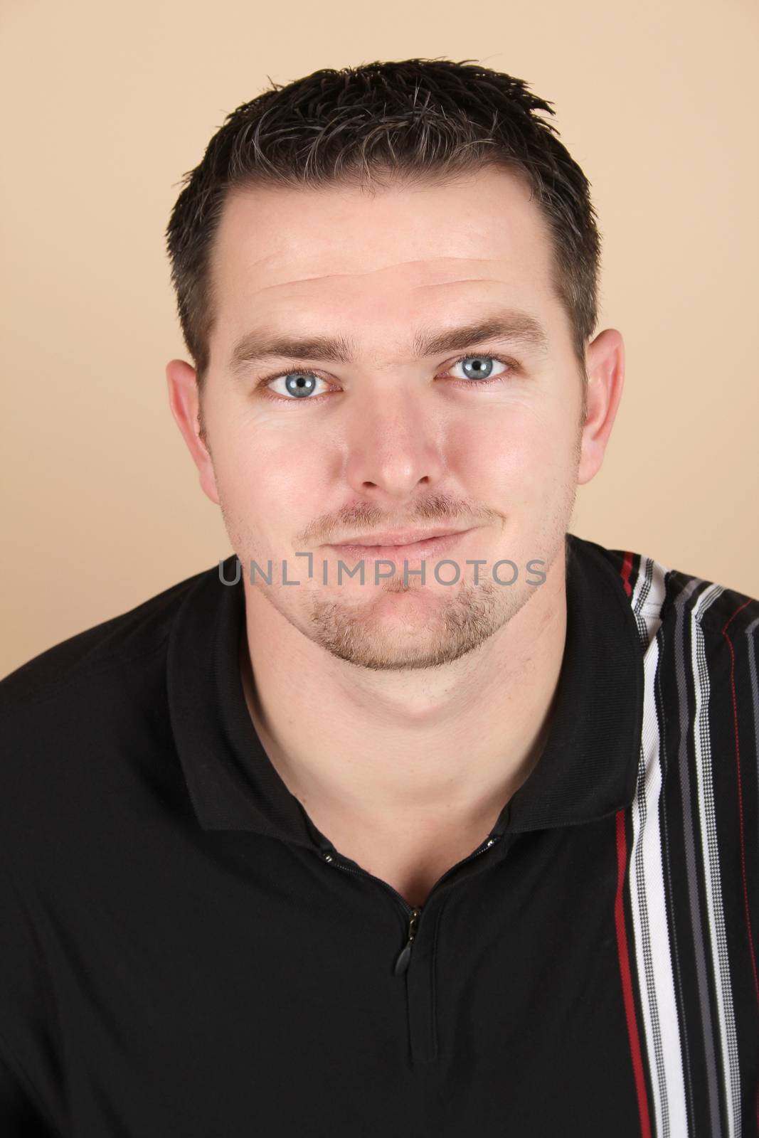 Attractive brunette male against a light background