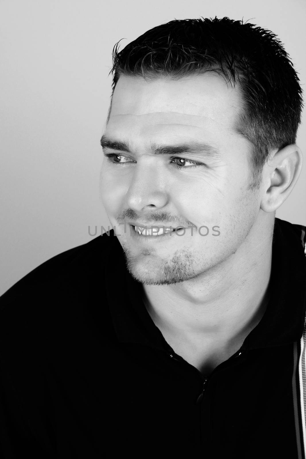 Attractive brunette male against a light background