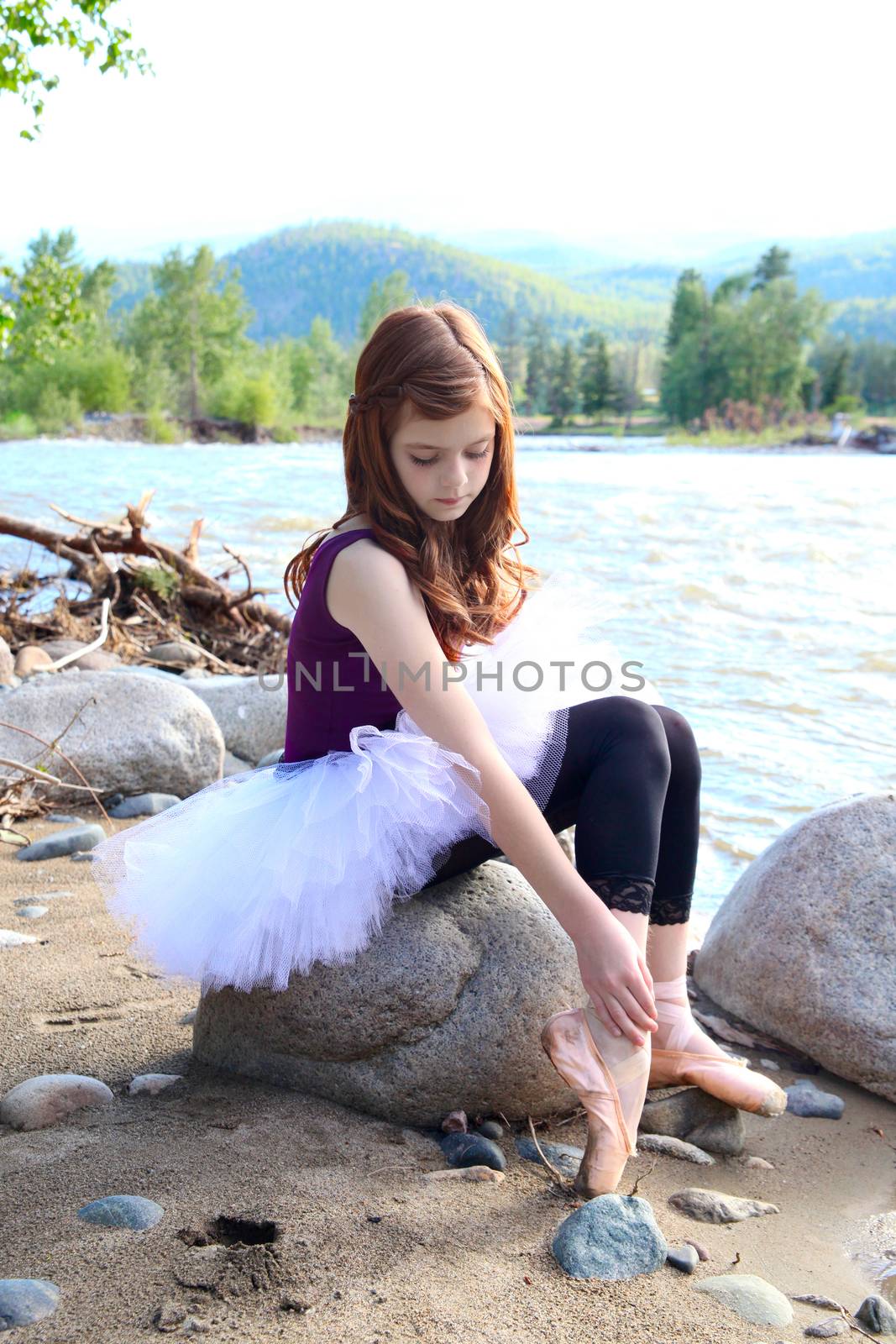 Beautiful girl wearing a white tutu by the river