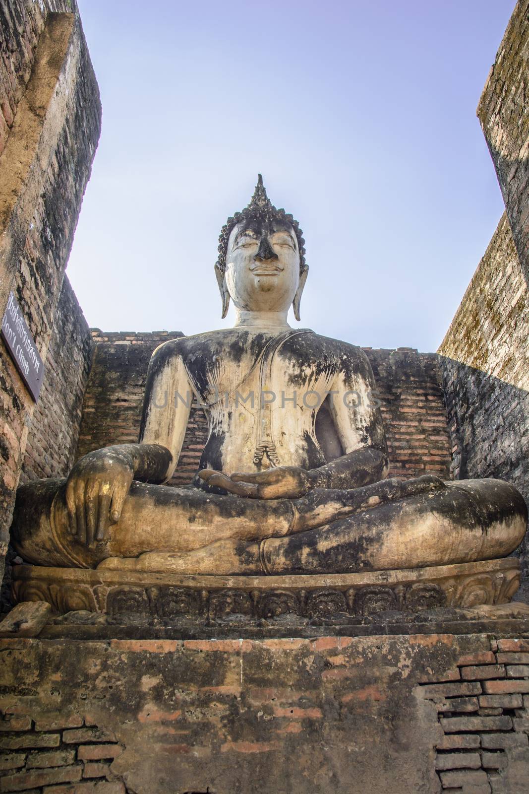 the old buddha statue in the Sukhothai Historical park in the Nort of Thailand