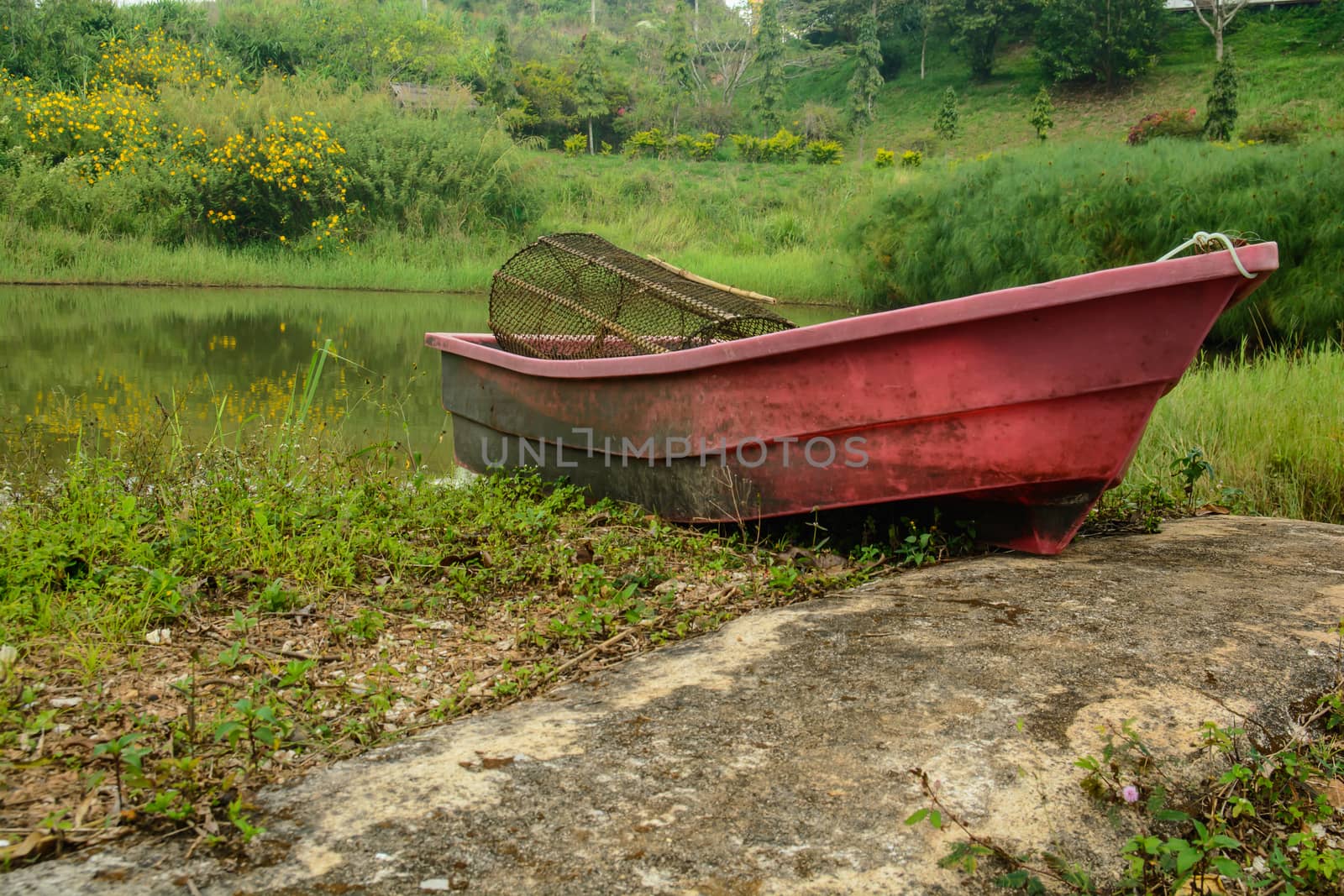 the old plastic boat on the shore of the rever