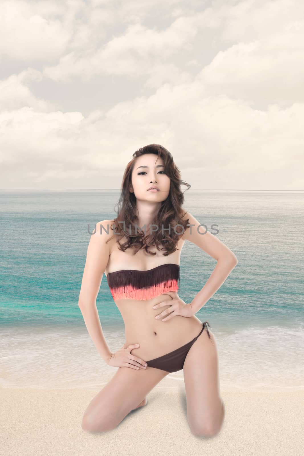 Young woman sit on beach by elwynn