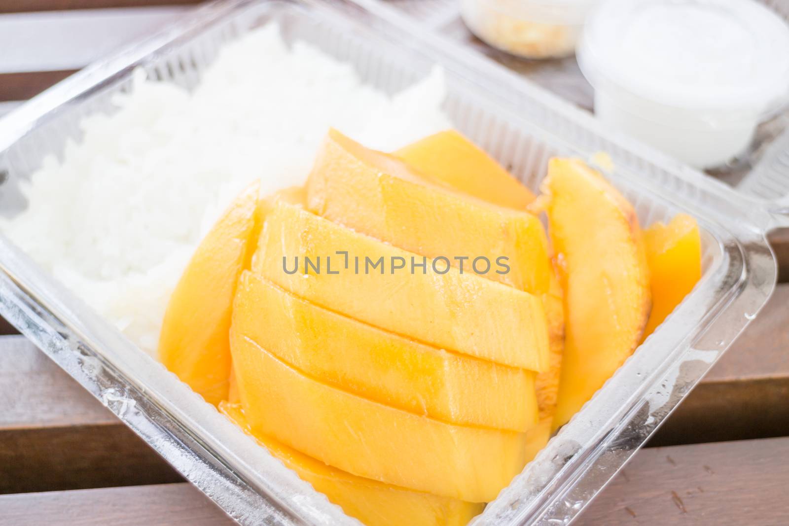 Close up dessert box of sweet mango and sticky rice by punsayaporn