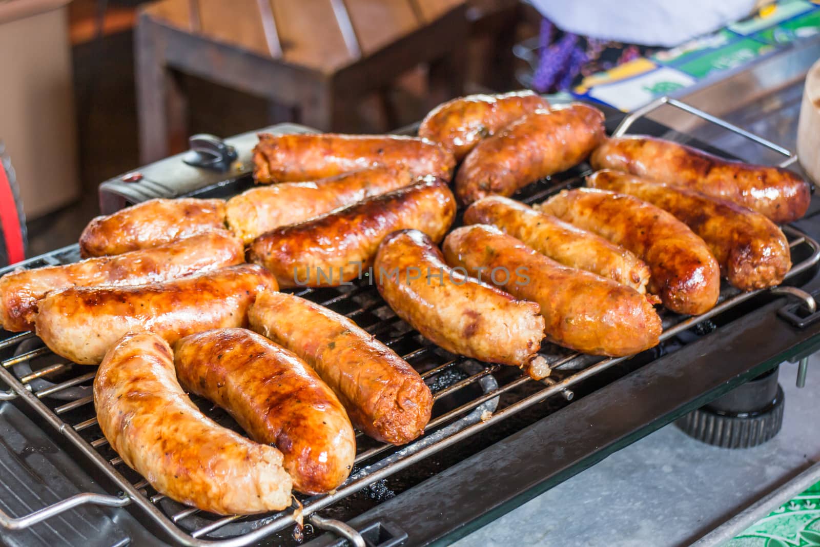 Grilled spicy sausages on the stove by punsayaporn