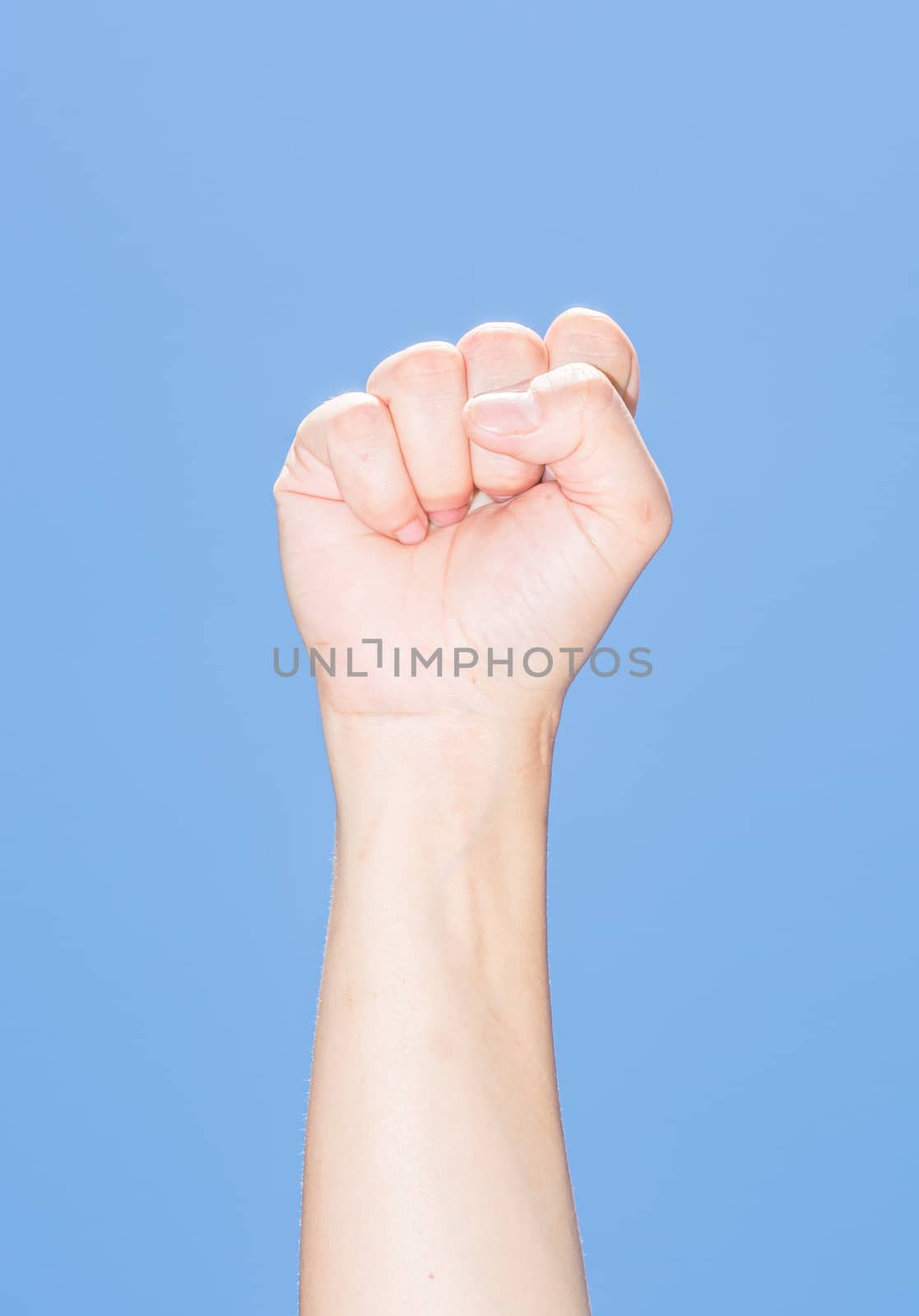 the isolated fighting hand under the beautiful blue sky