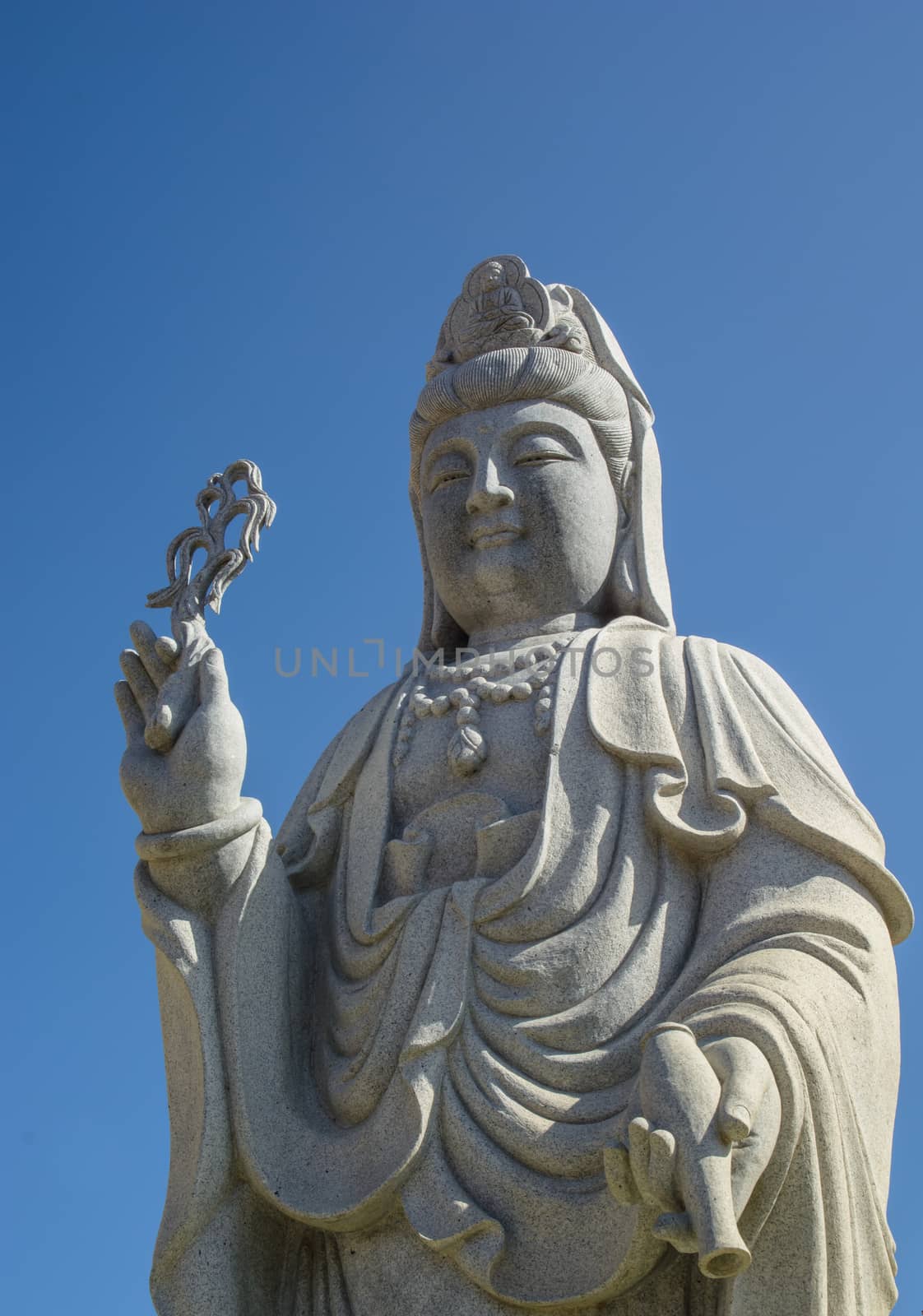 Guanyin statue standing in front of Chinese temple. This is a symbol of Chinese people who are buddhism.