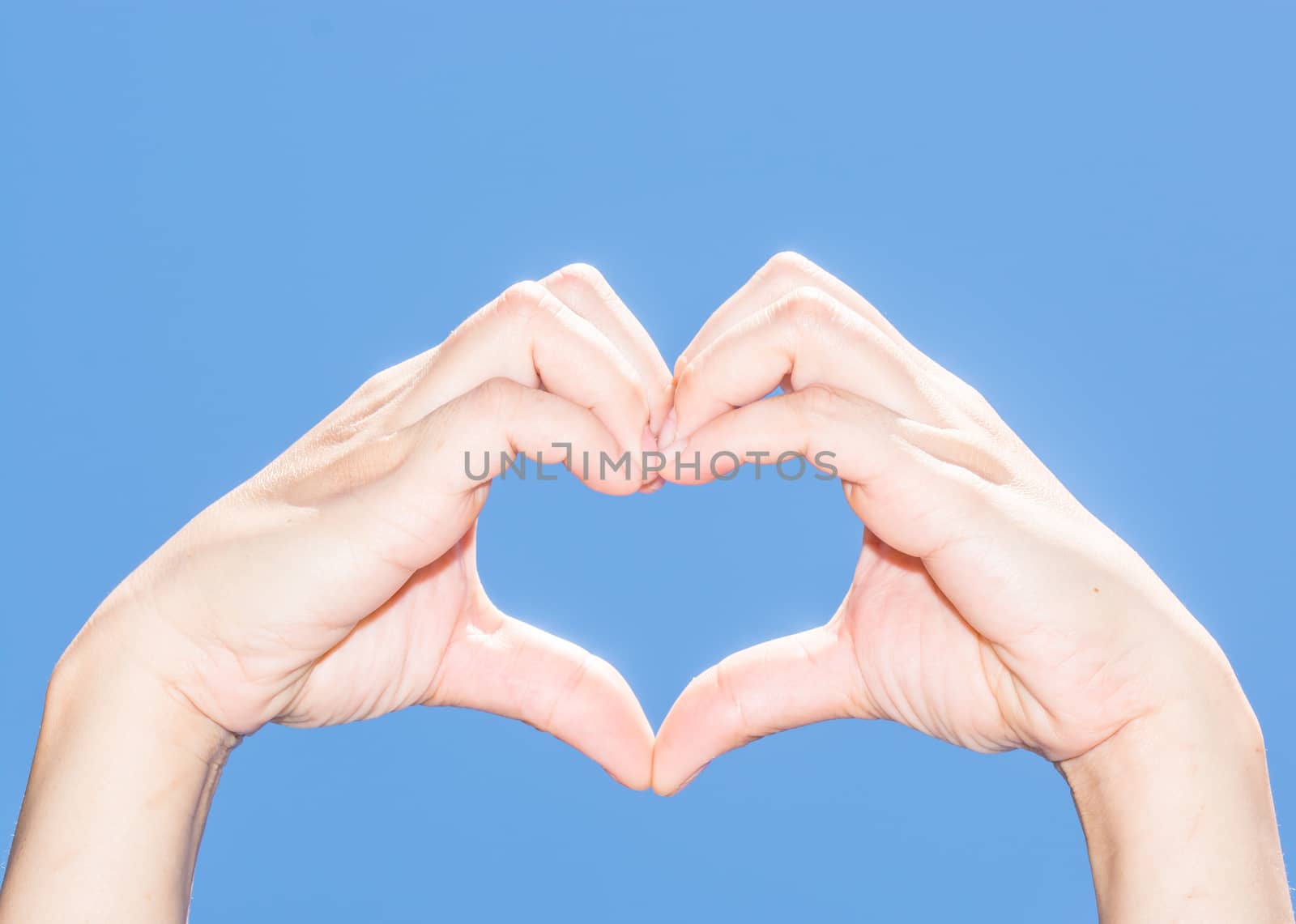 The isolated female hand showing her heart indicates her love to everyone