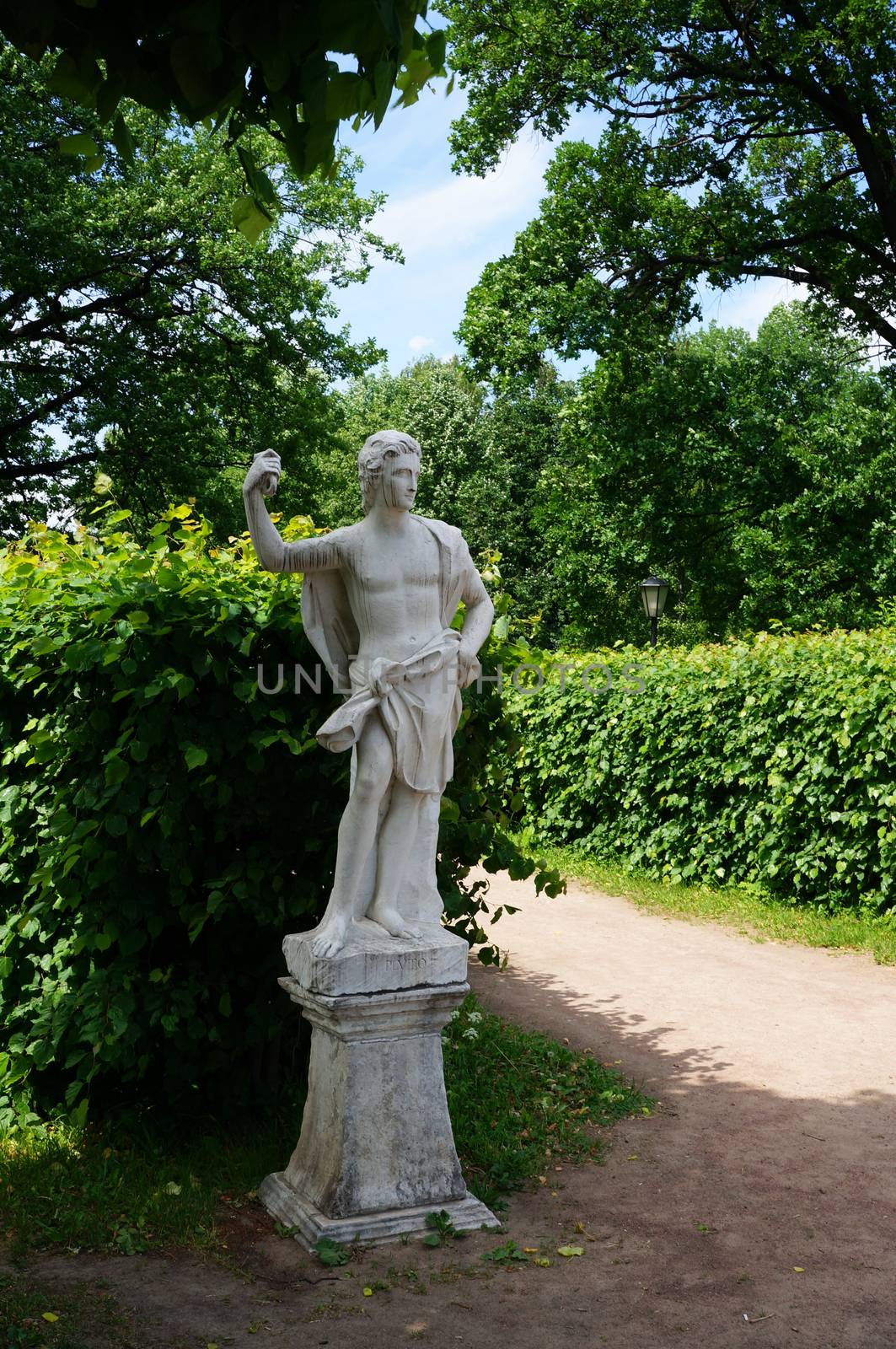 White marble statue in a summer park by Chiffanna