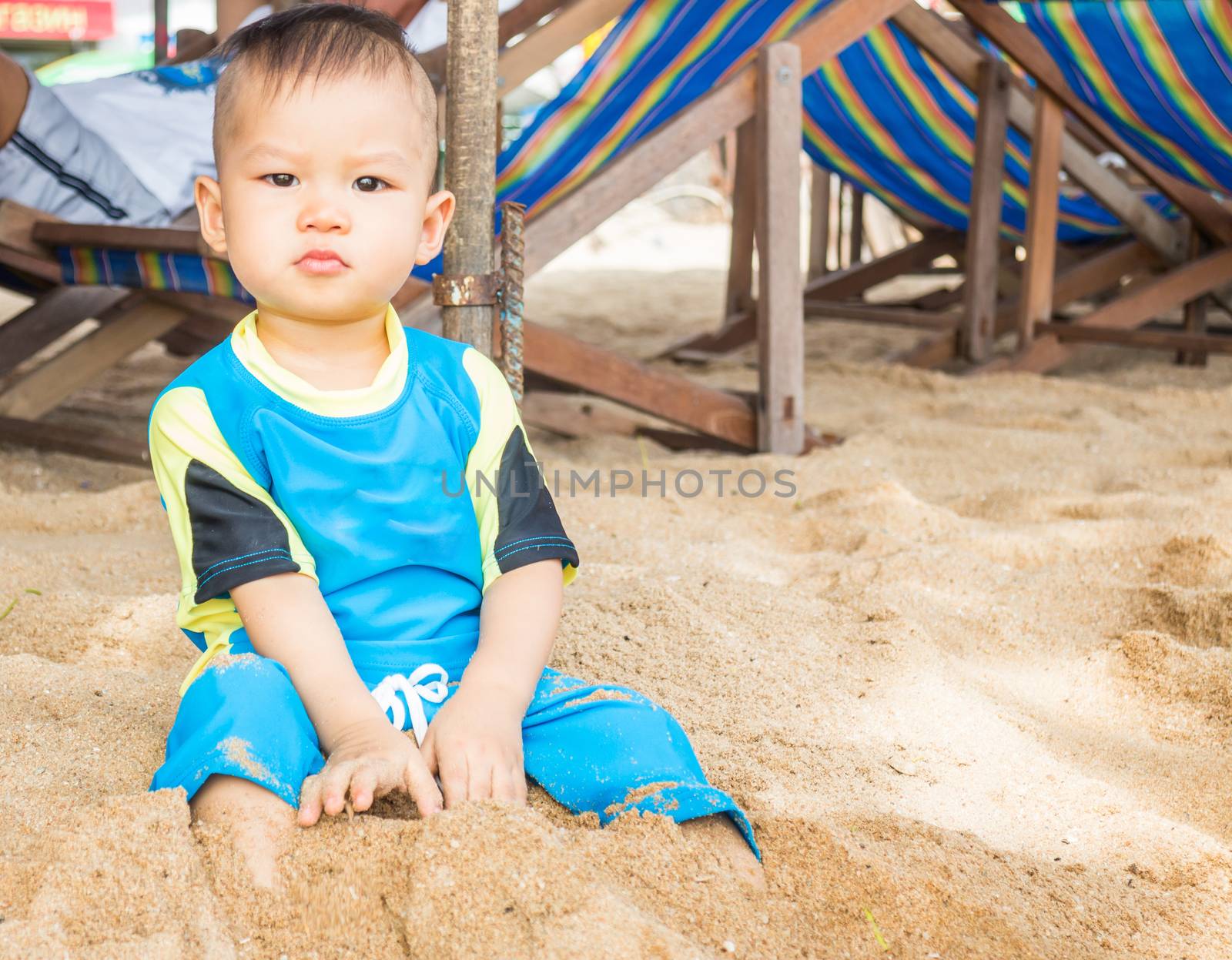 Asian boy playing on the beach, stock photo