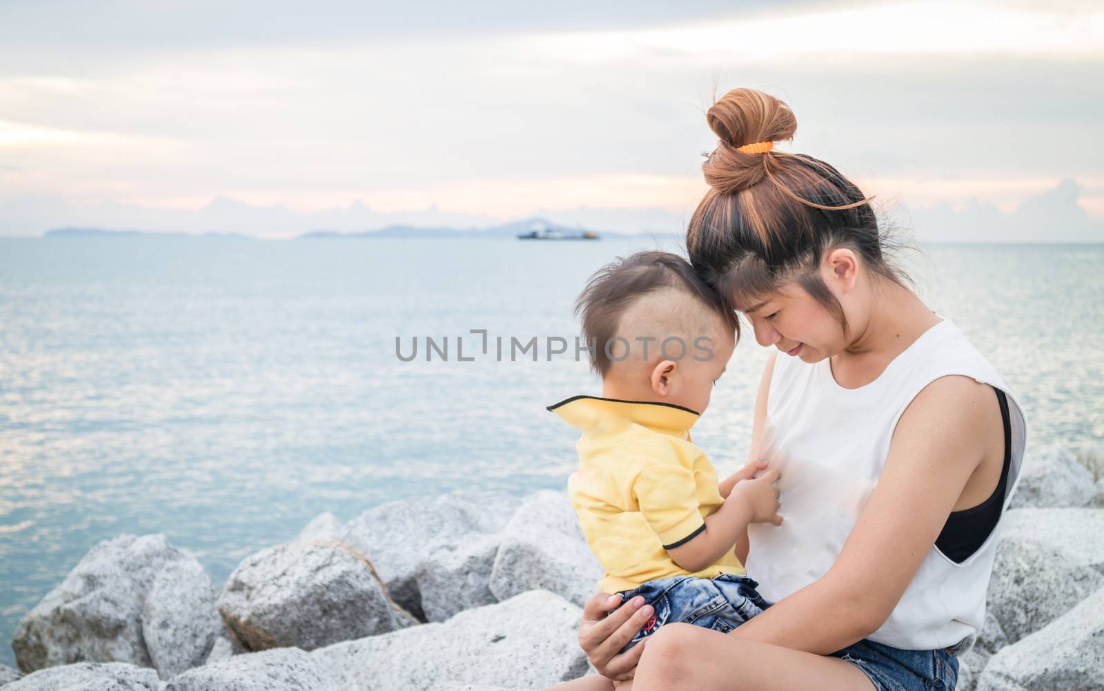 Cute asian boy playing with his mother  by punsayaporn