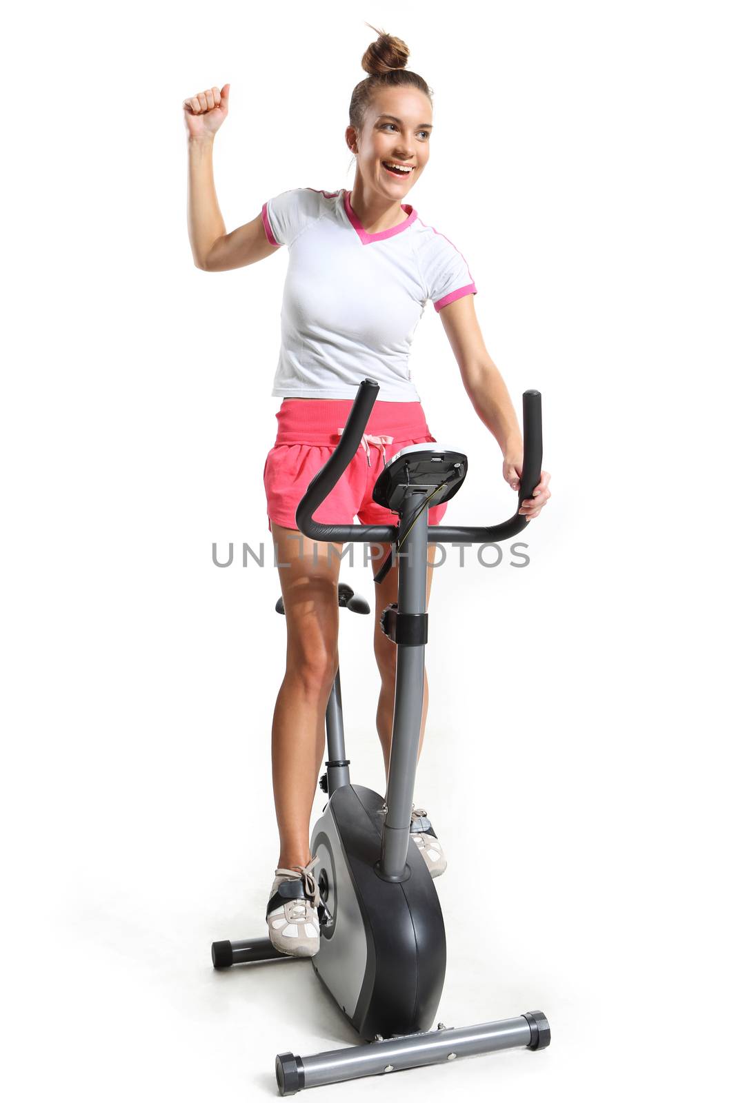 Woman on exercise bike pedals