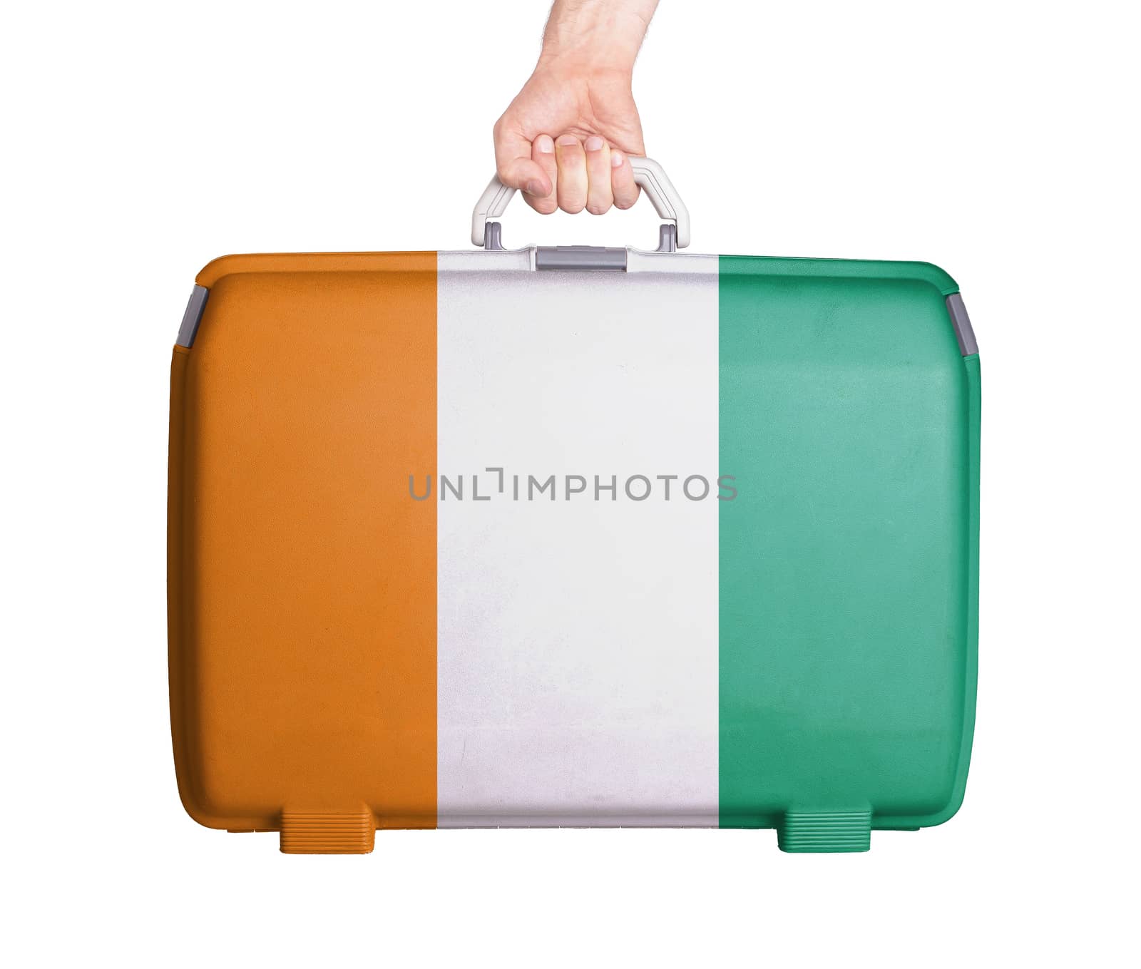 Used plastic suitcase with stains and scratches, printed with flag, Ivory Coast