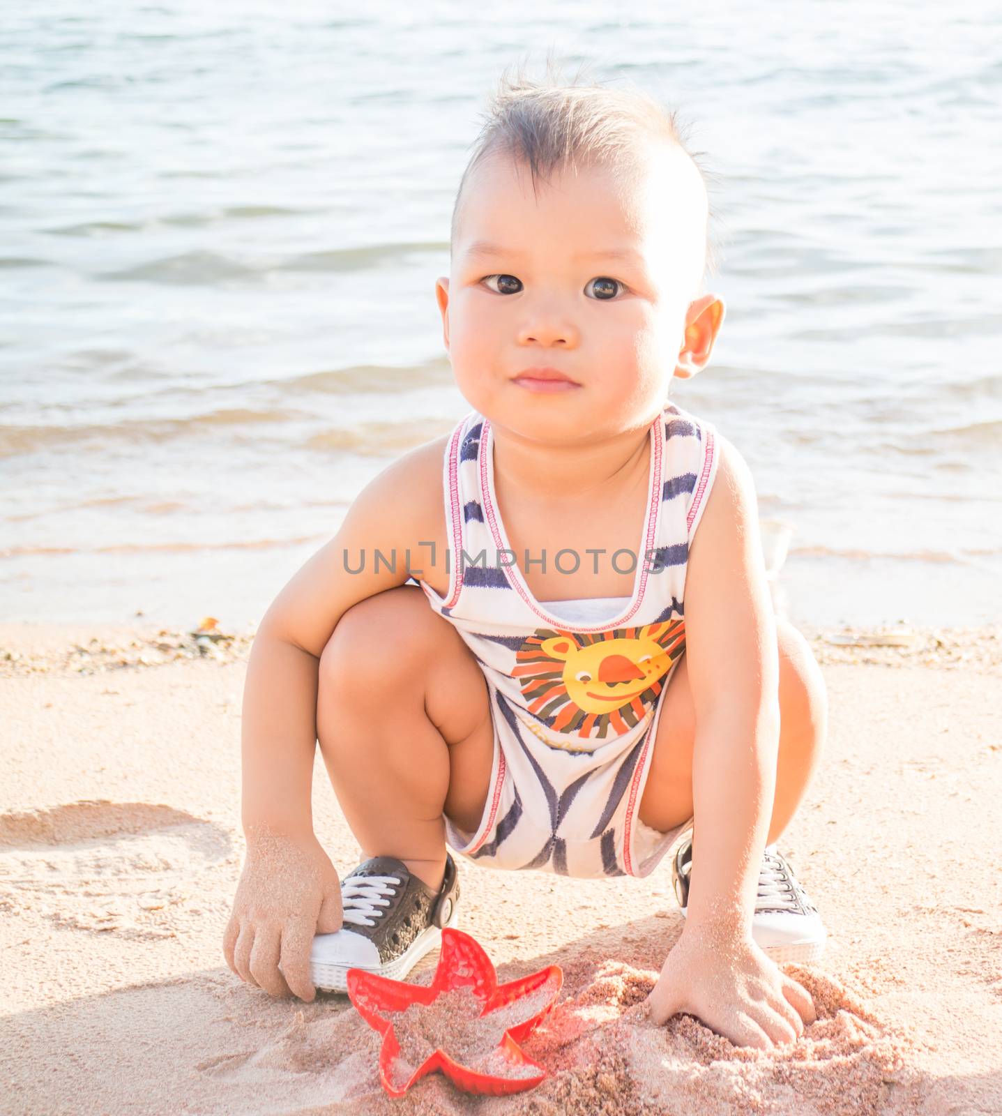 Little boy playing on the beach-WB by punsayaporn