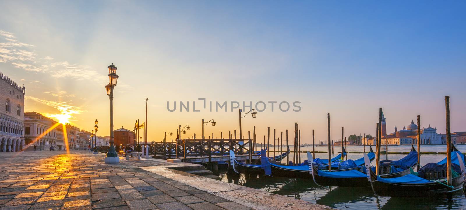Panoramic view of Venice with gondolas at sunrise