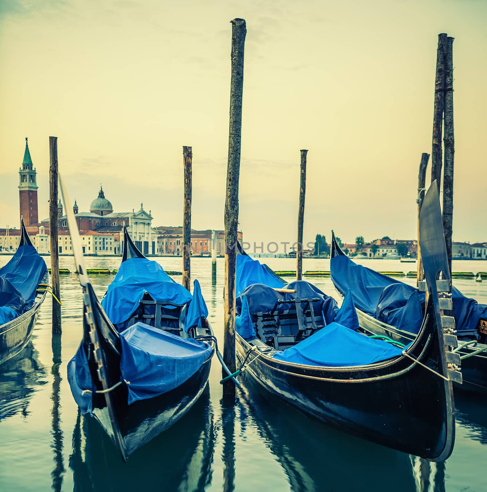 Gondolas floating in the Grand Canal at sunset, special photographic processing.