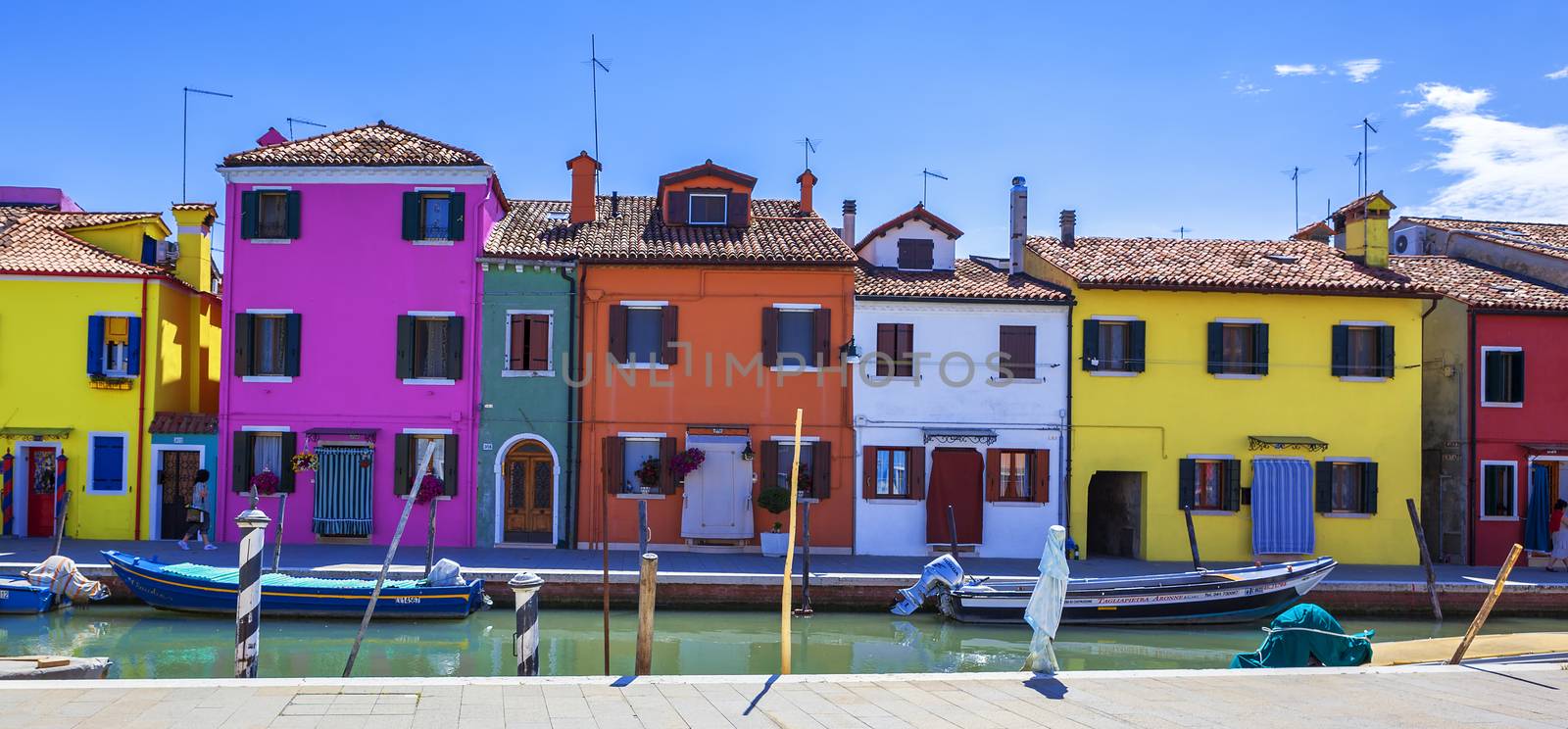 Colorful street with canal in Burano, near Venice, Italy 