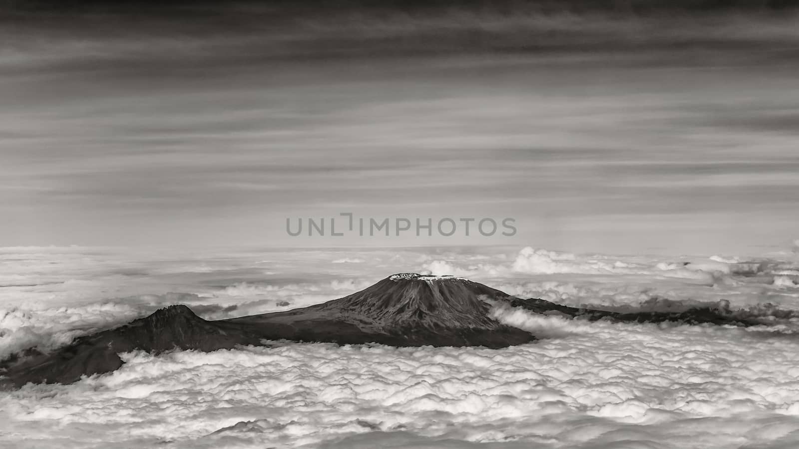 The tallest mountain in Africa, Mount Kilimanjaro, soaring above the clouds