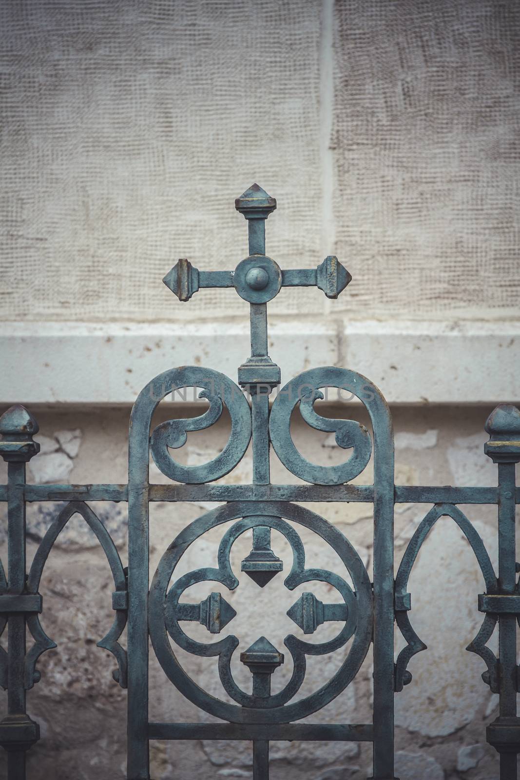 iron cross, fence with decorative metal flourishes