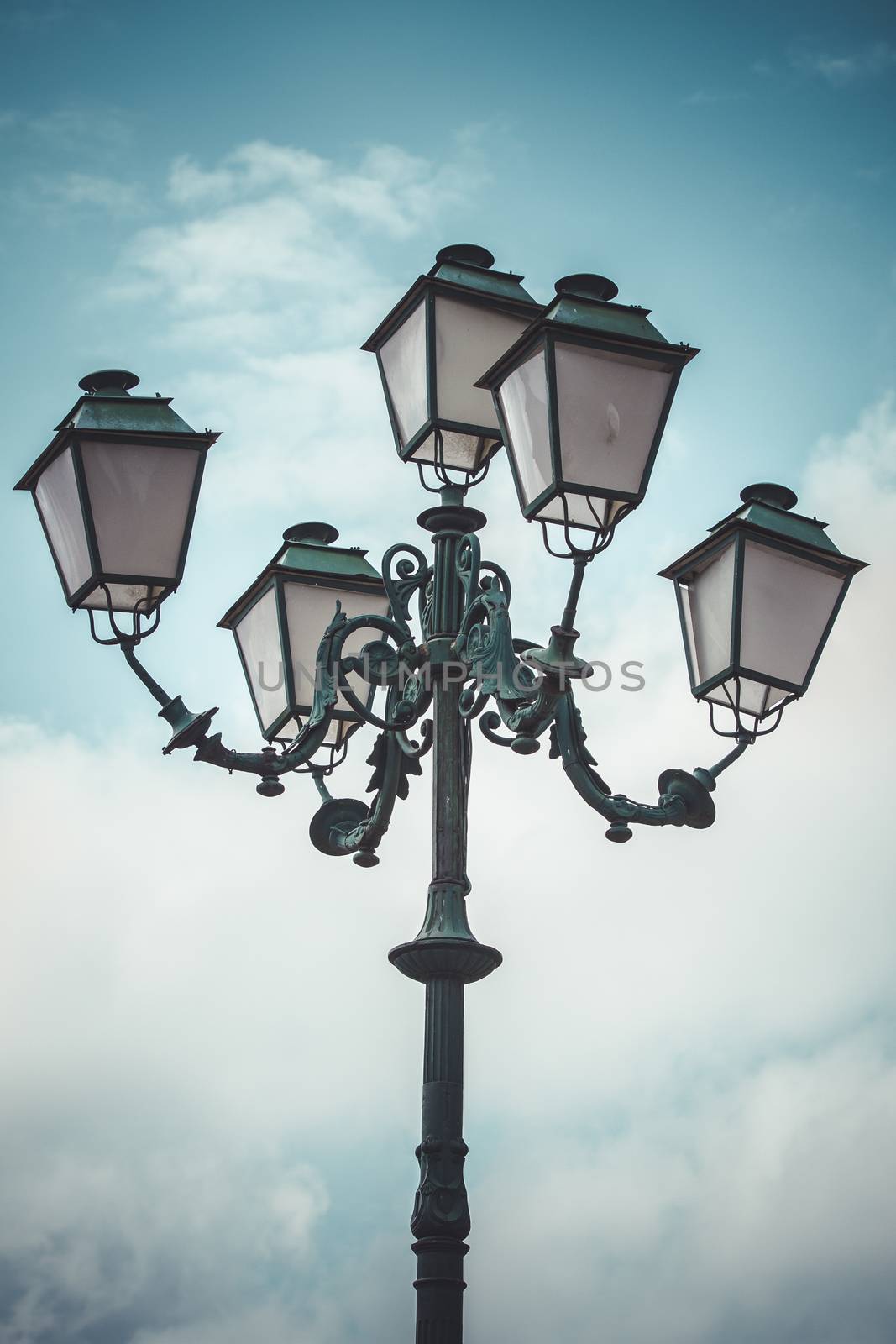 vertical, traditional street lamp with decorative metal flourishes