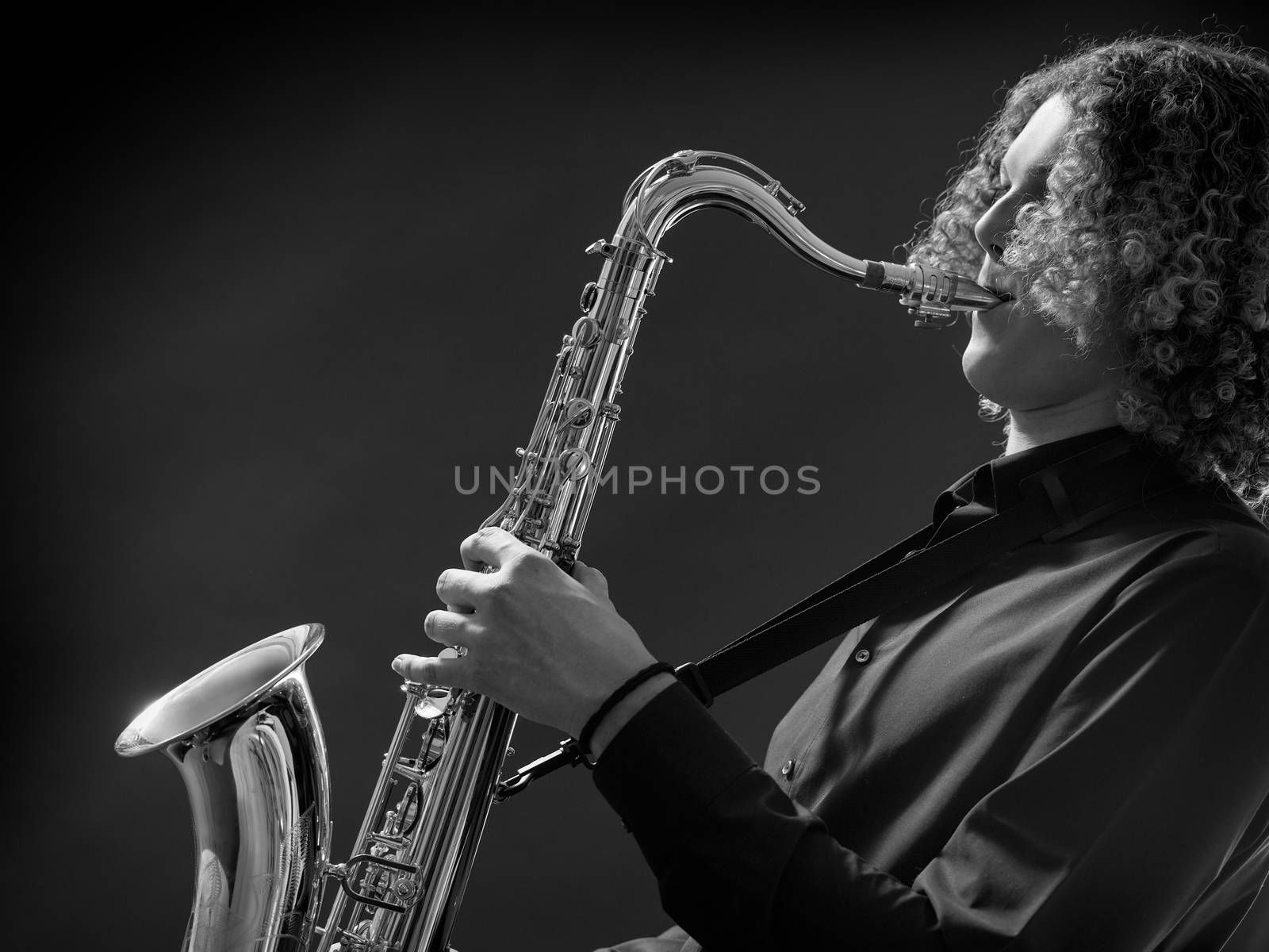 Young teen playing the saxophone by sumners