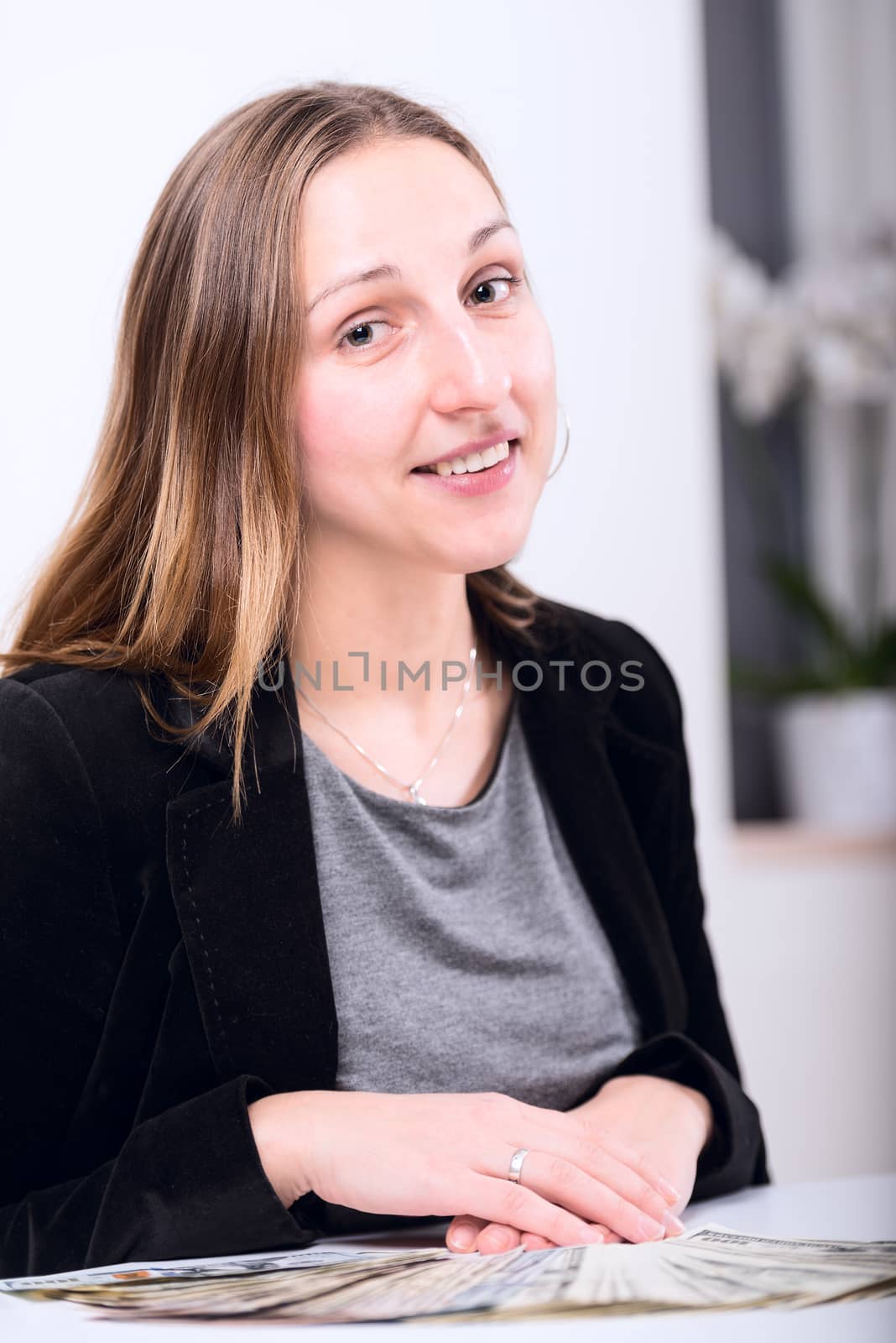 Brunette young woman with money on table