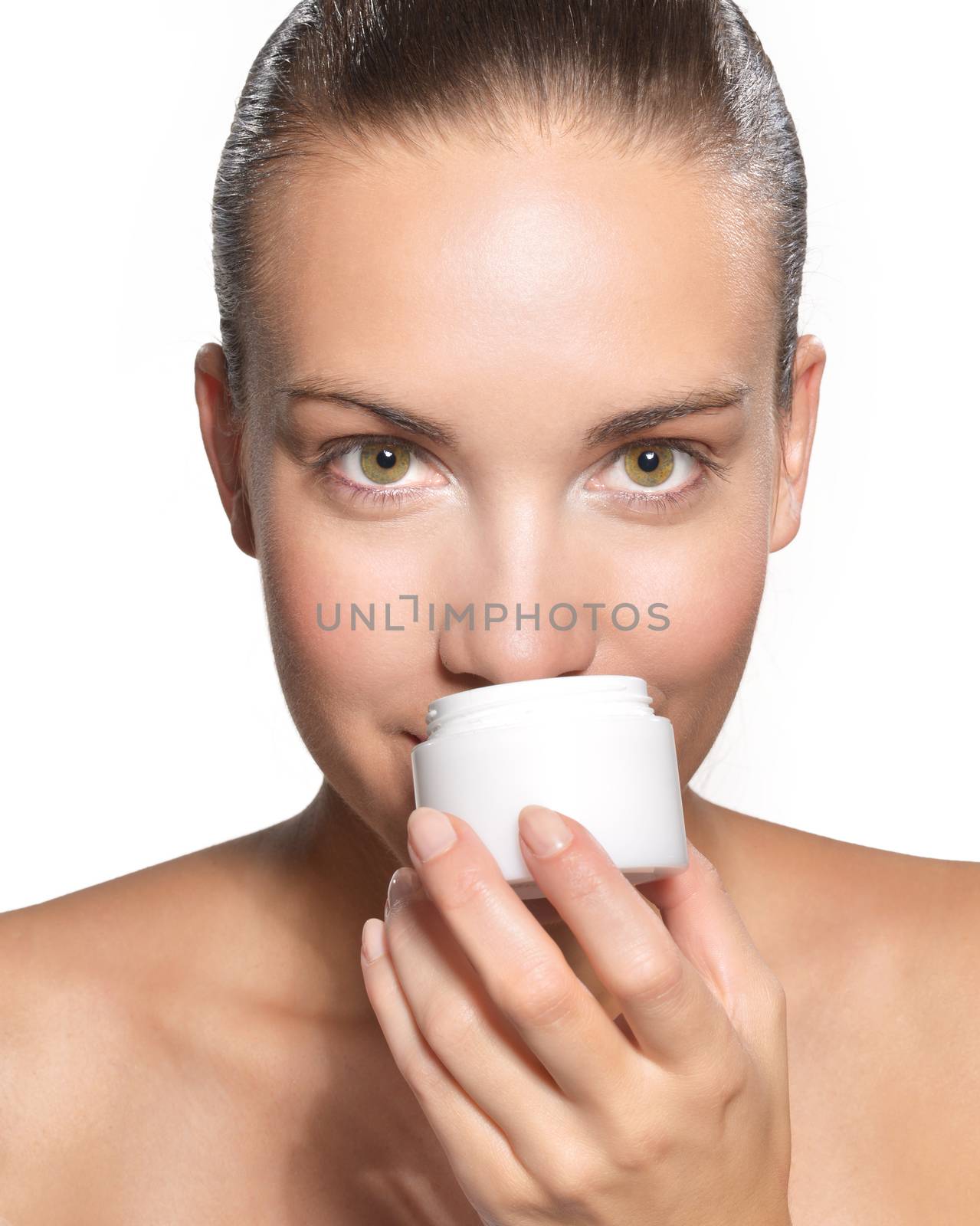 Close-up portrait of happy young beautiful woman holding moisturizing facial cream