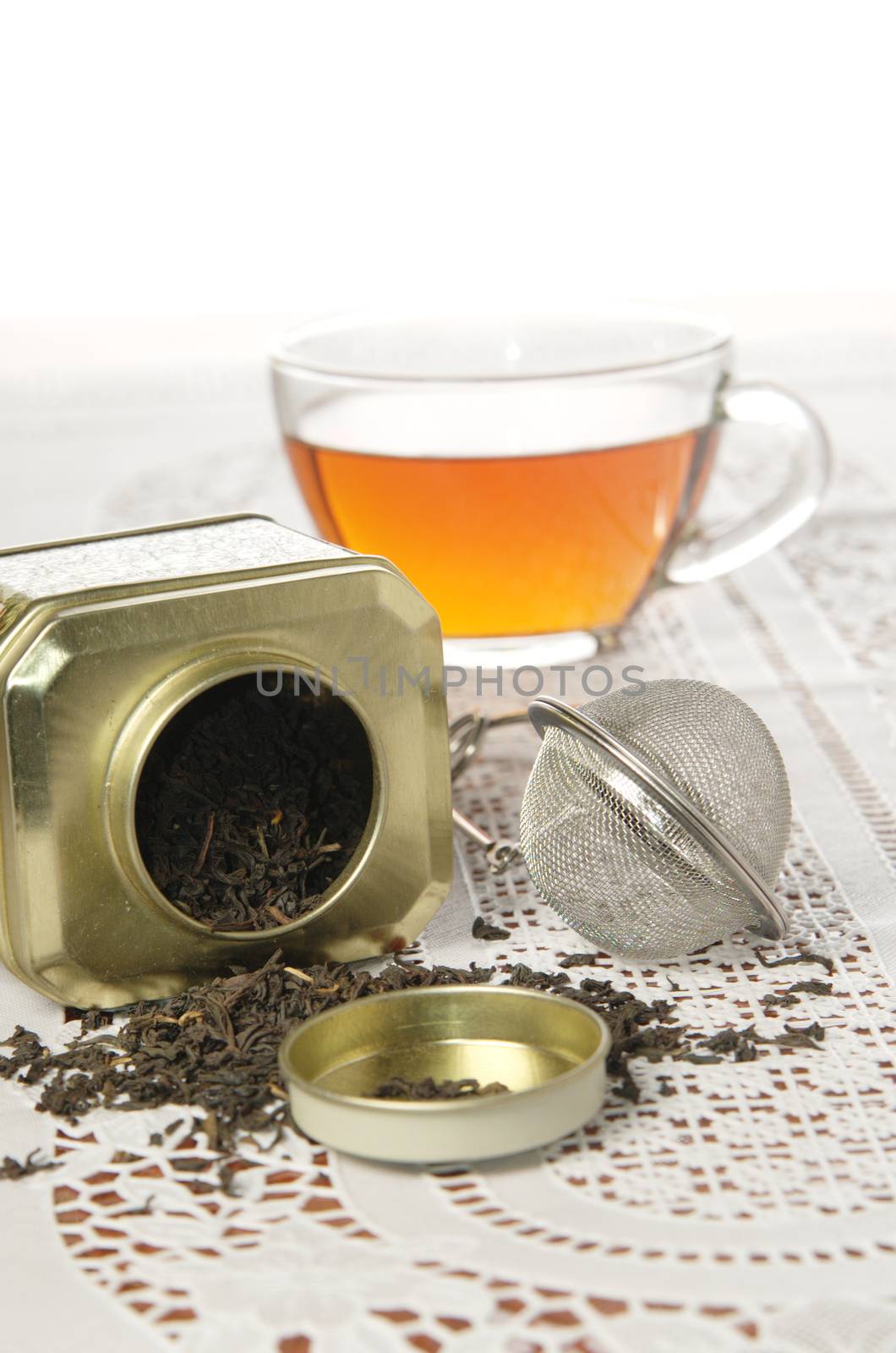 A silver spoon next to two jars of tea