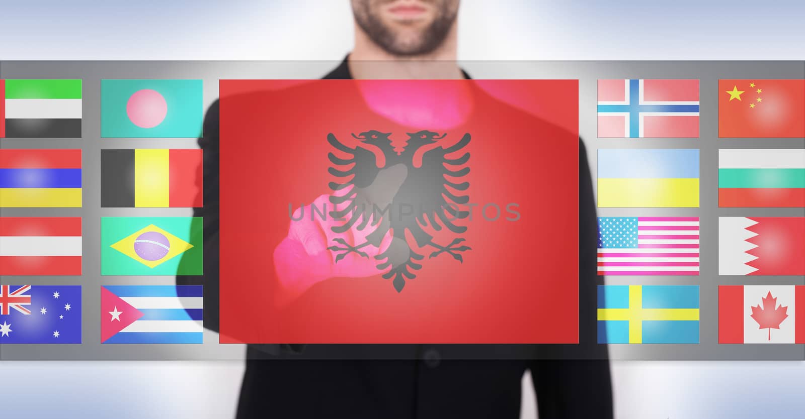 Hand pushing on a touch screen interface, choosing language or country, Albania