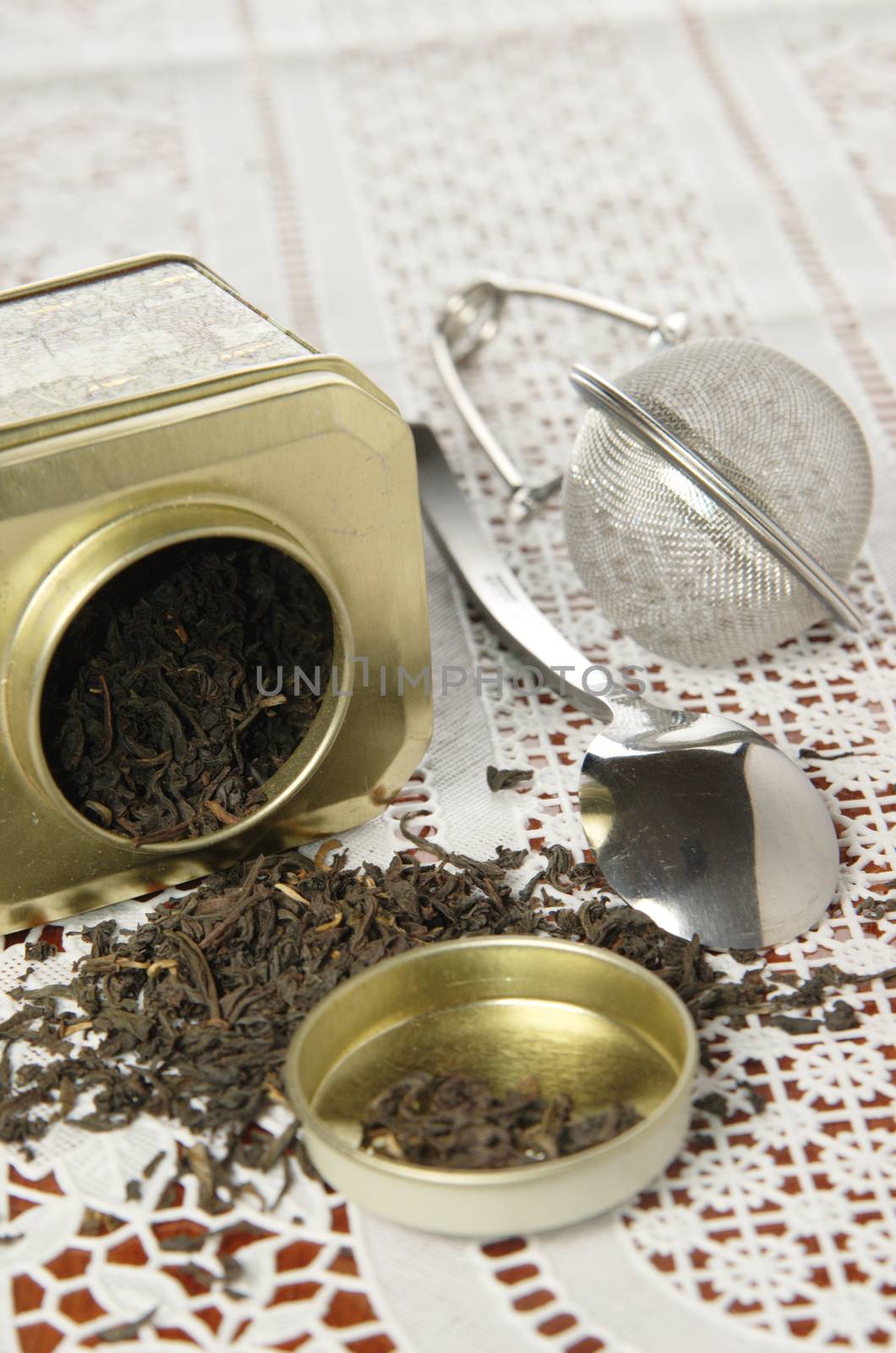 A silver spoon next to two jars of tea