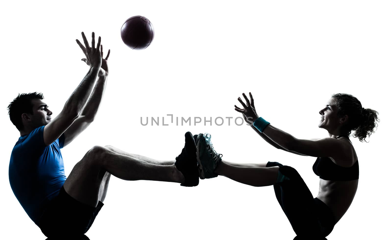 one  couple man woman personal trainer coach exercising tossing fitness ball silhouette studio isolated on white background