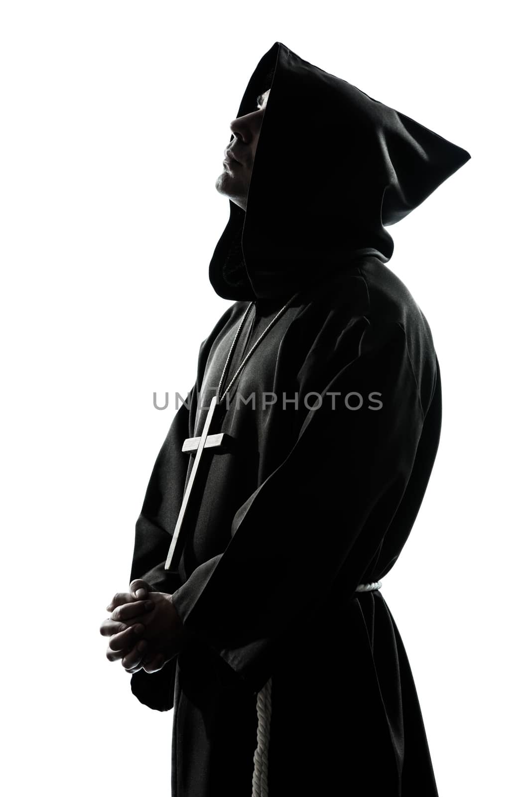 one  man priest praying silhouette in studio isolated on white background