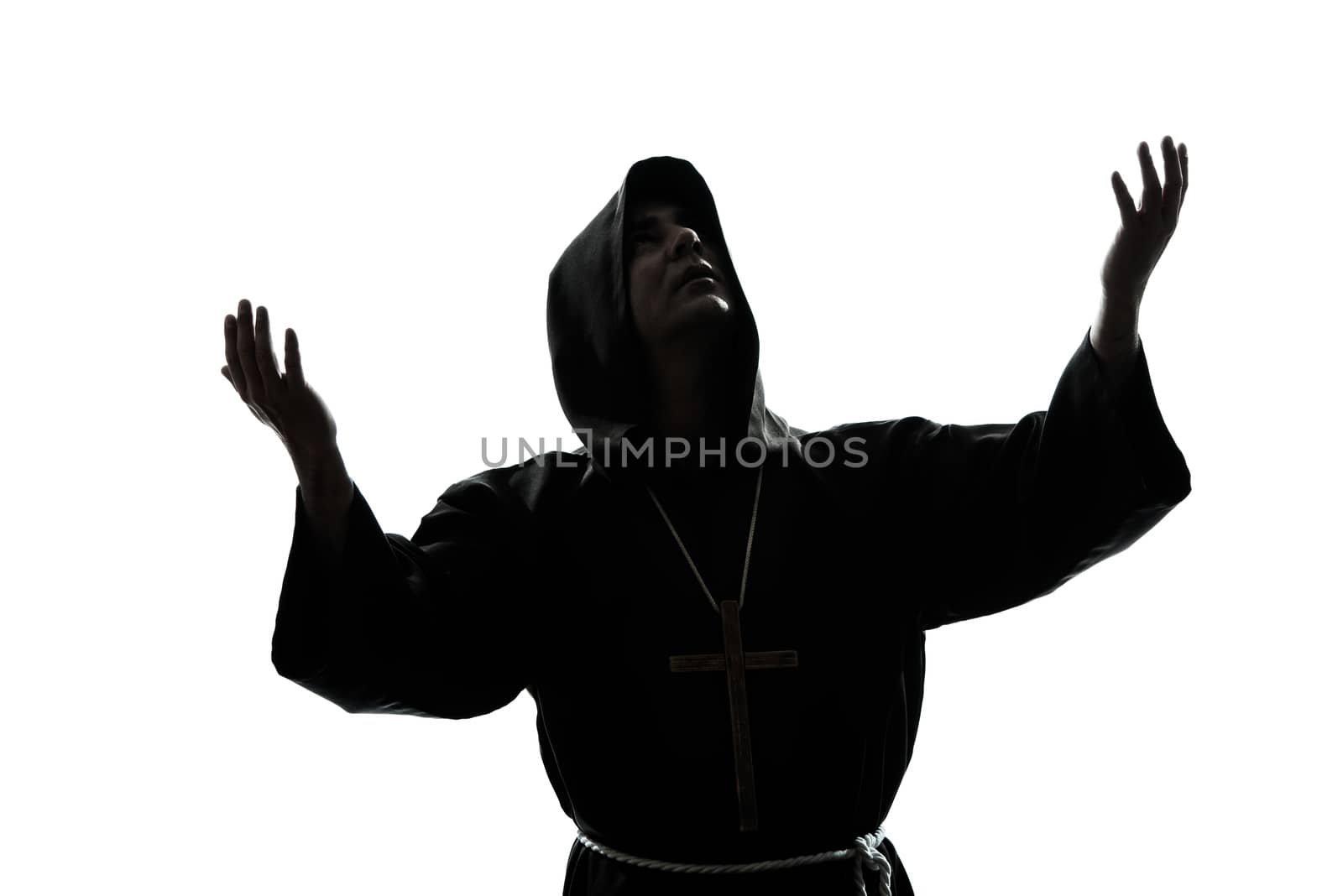 one  man priest praying silhouette in studio isolated on white background