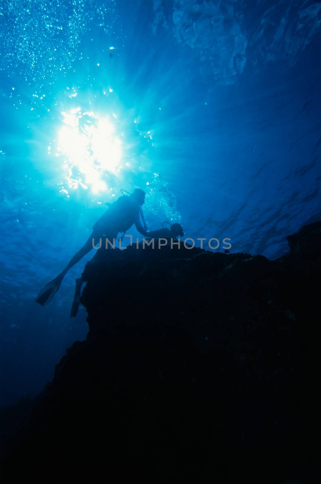 Sun Burst and Scuba Divers on Reef