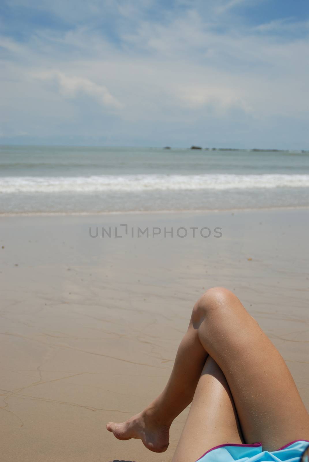 Stock photo of beautiful tall brunette woman on the beach in the tropics