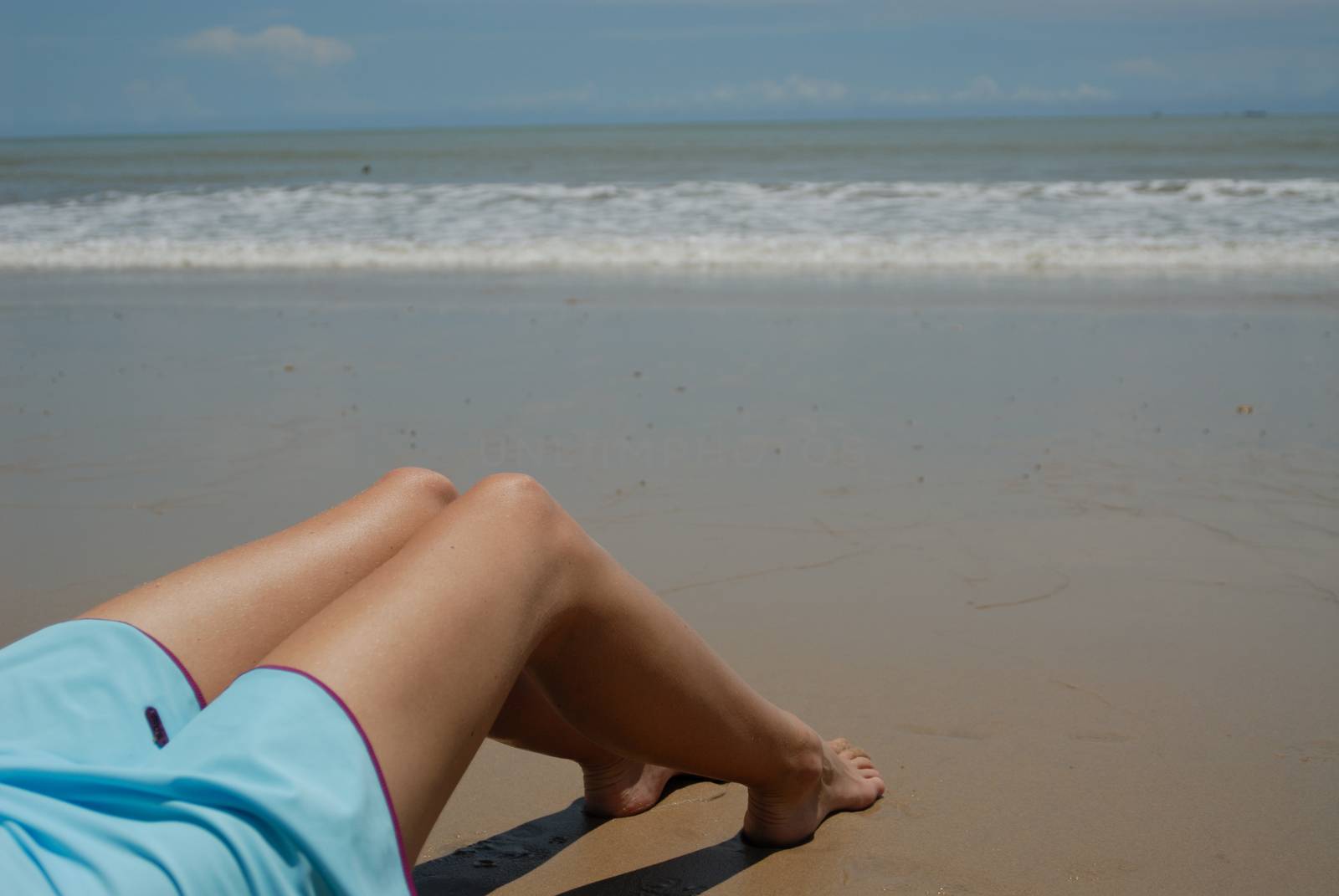 Stock photo of beautiful tall brunette woman on the beach in the tropics