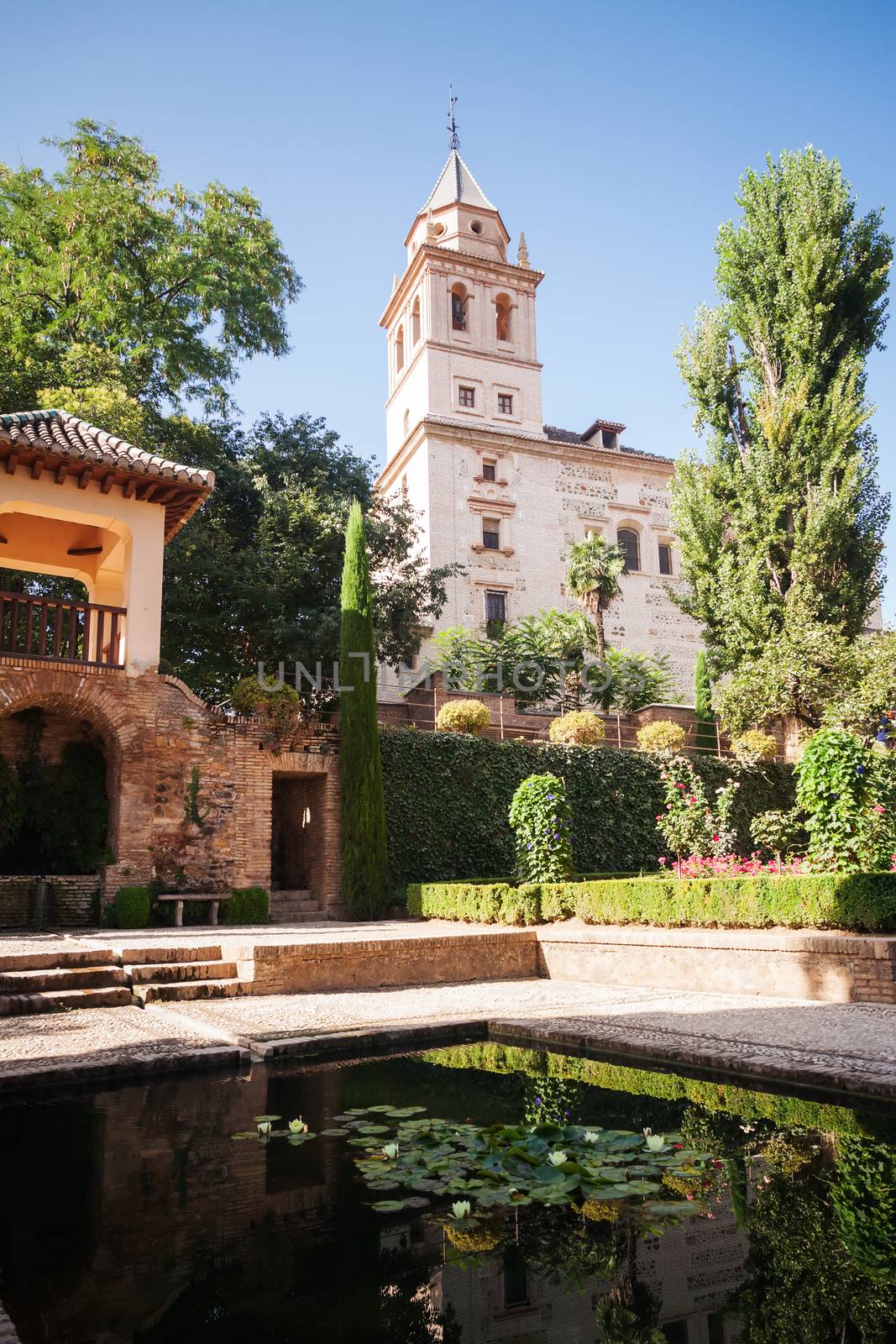 Belltower of St. Mary Church in Generalife gardens  by serpl