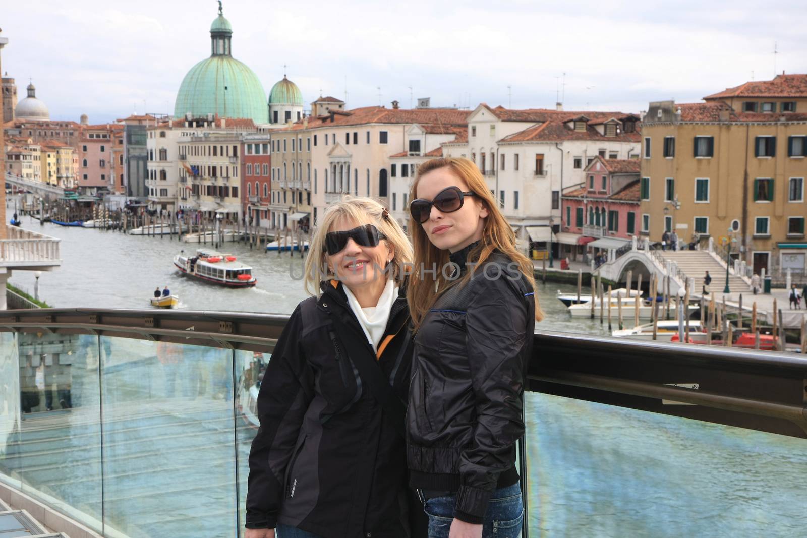 Two ladies posing on the bridge in Venice,Italy