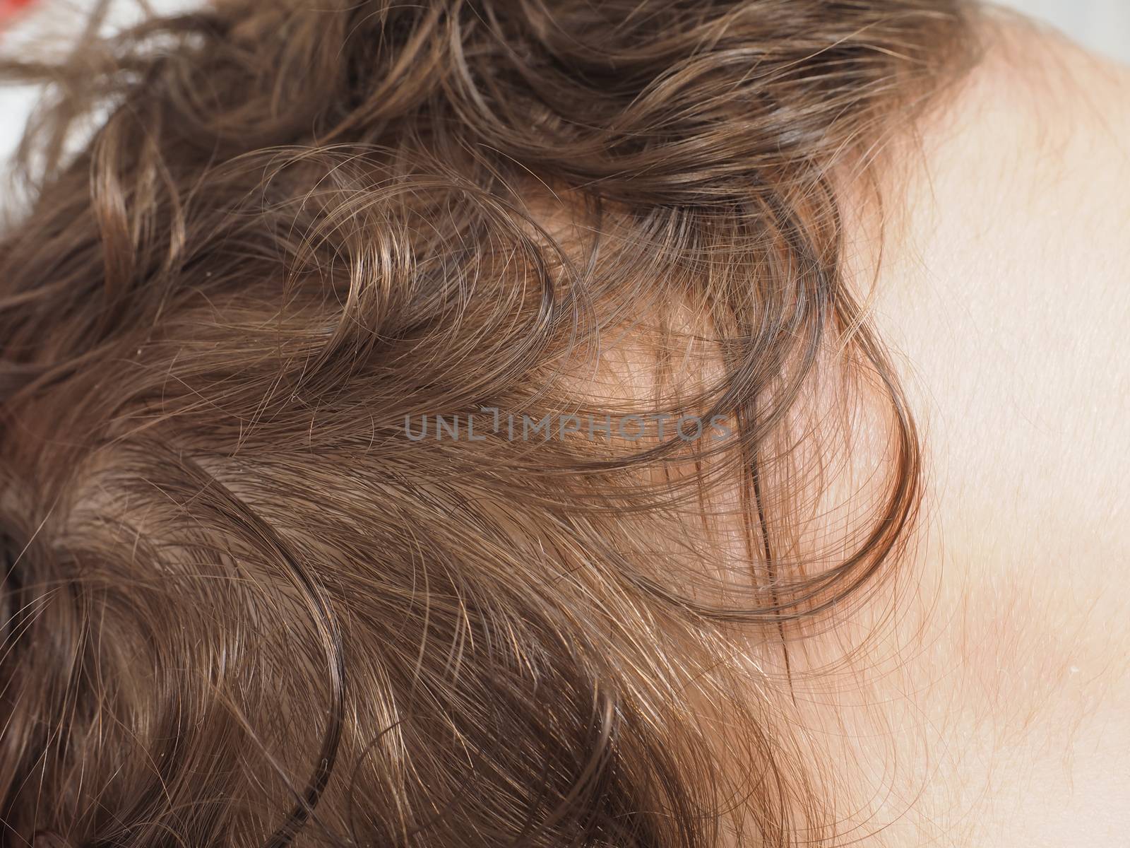 Closeup of an infants brown curly hair