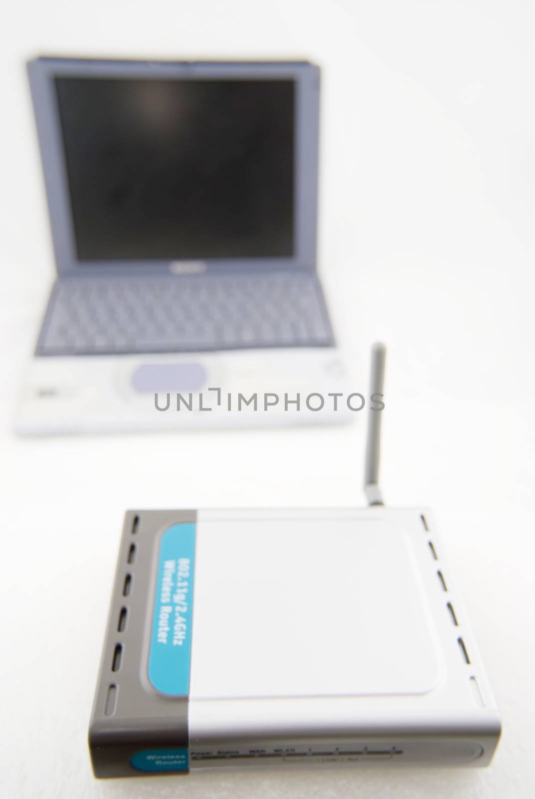 Silver Laptop and wireless router by seawaters
