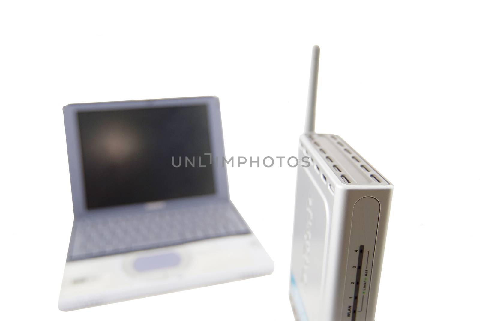 A modern silver laptop with wireless router