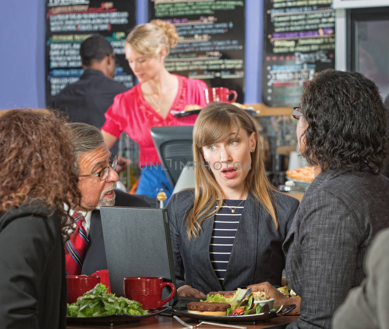 Diverse mature business executives meeting in cafeteria