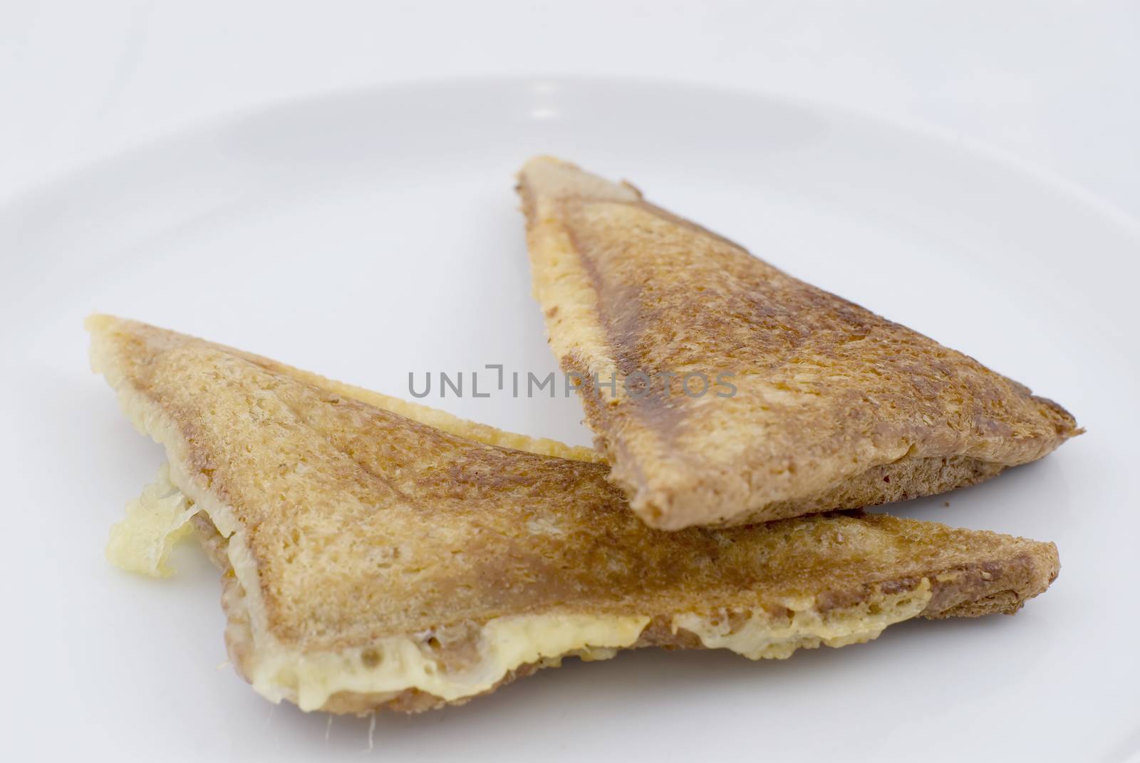 A Cheese and Onion toasted sandwich on white plate