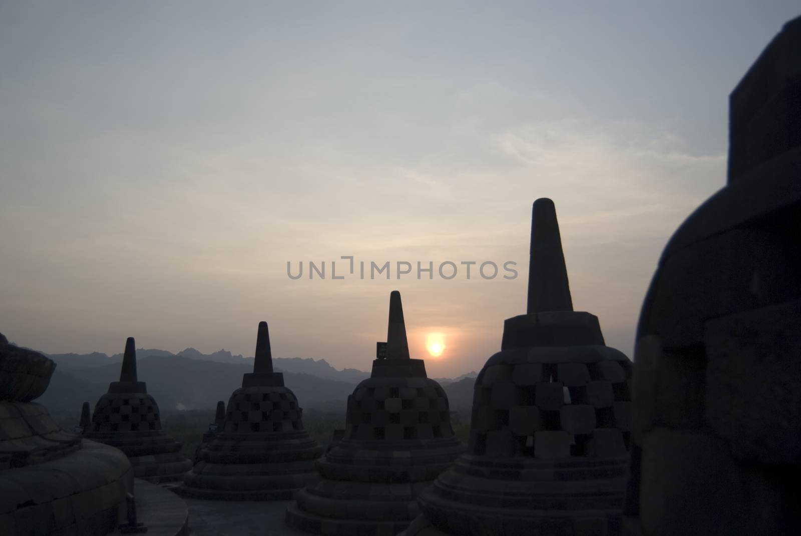 The sun setting over Borobudur Temple