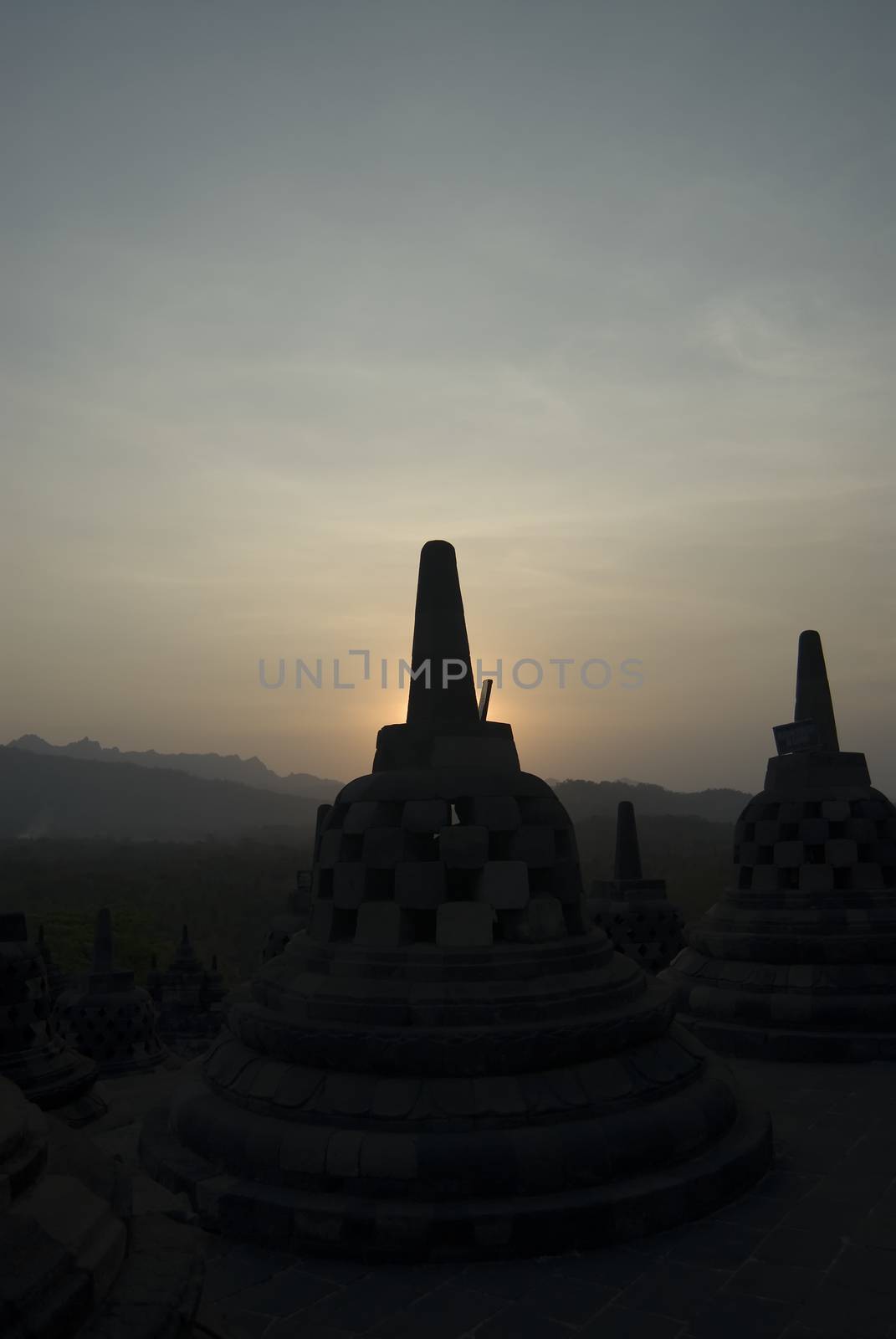 The sun setting over Borobudur Temple