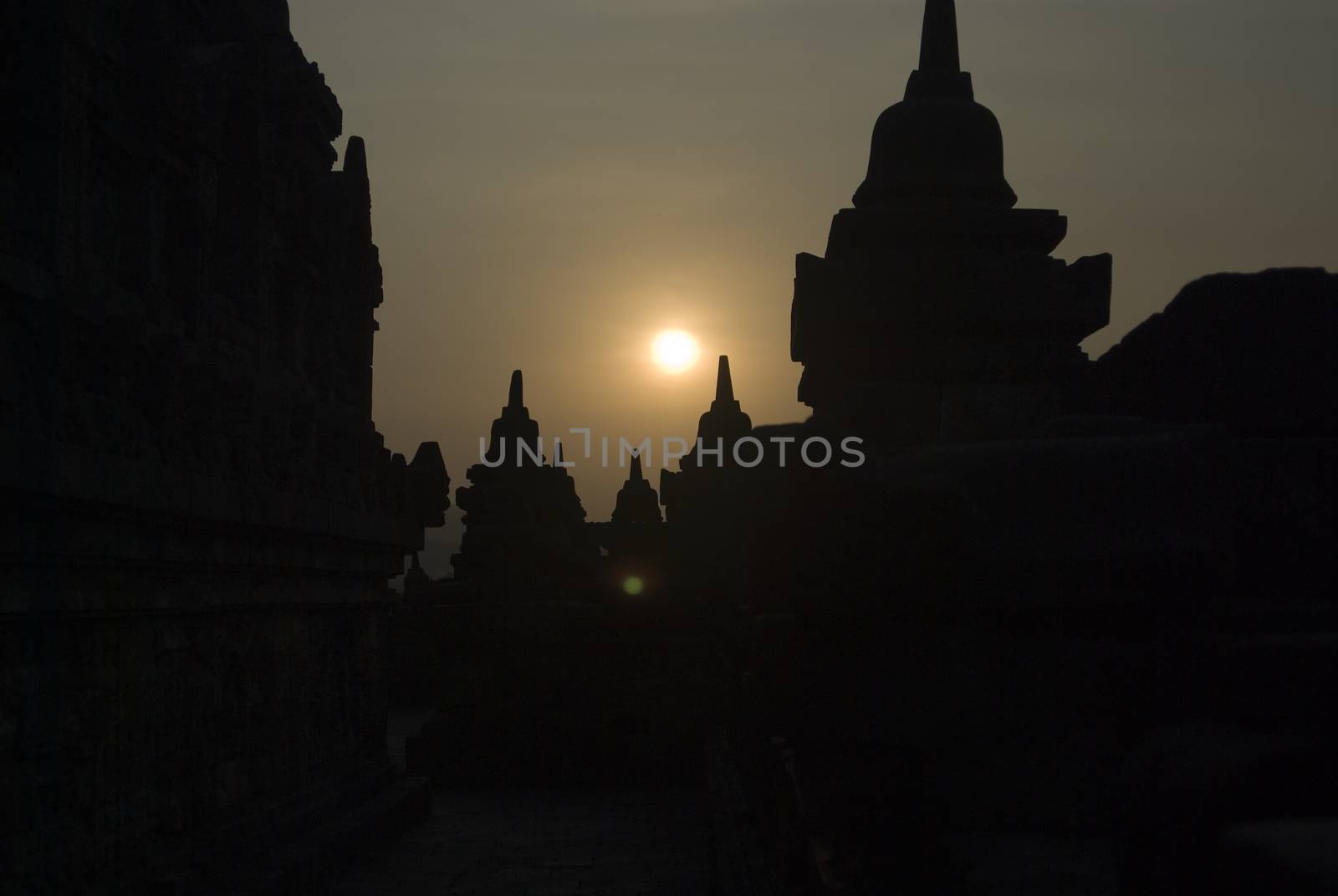 The sun setting over Borobudur Temple